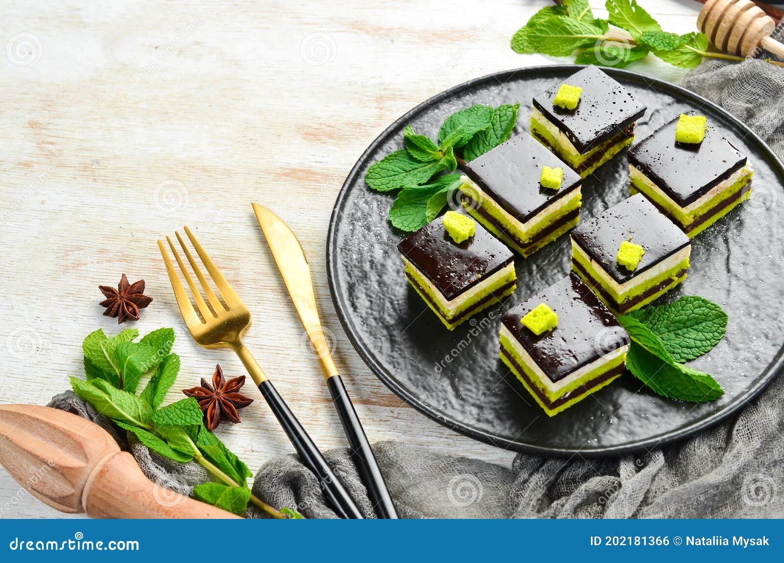 Chocolate Mousse Dessert Opera on a Black Plate with Mint. Top View