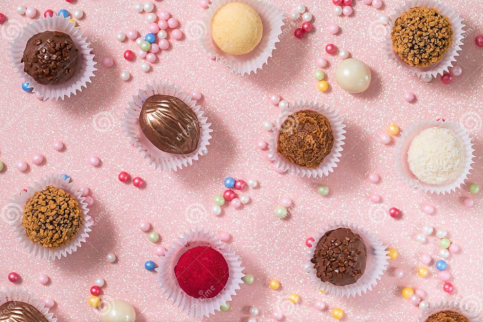Chocolate, Nut and Coconut Candies on a Pink Background, Decorated with
