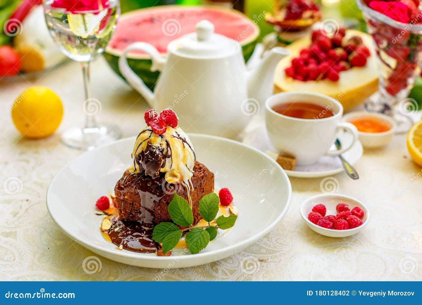 Chocolate Sponge Cake with Ice Cream and Fruit on a Served Table Stock