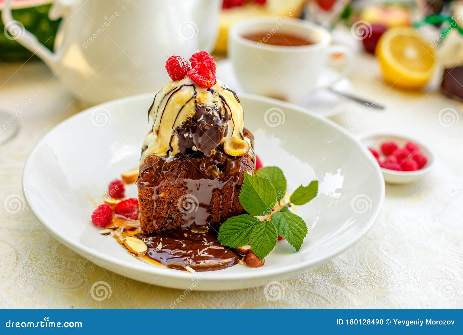 Chocolate Sponge Cake with Ice Cream and Fruit on a Served Table Stock