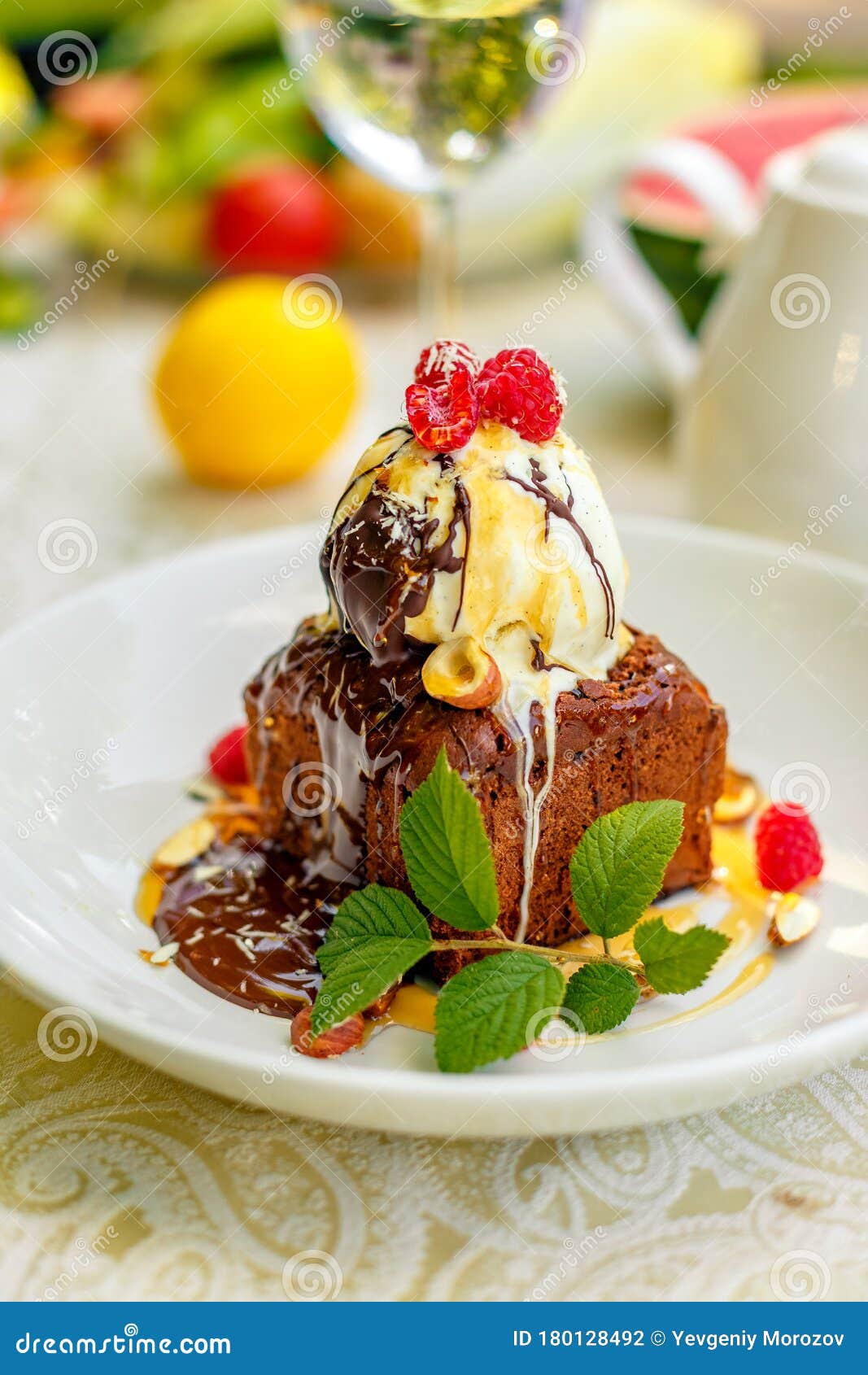 Chocolate Sponge Cake with Ice Cream and Fruit on a Served Table Stock