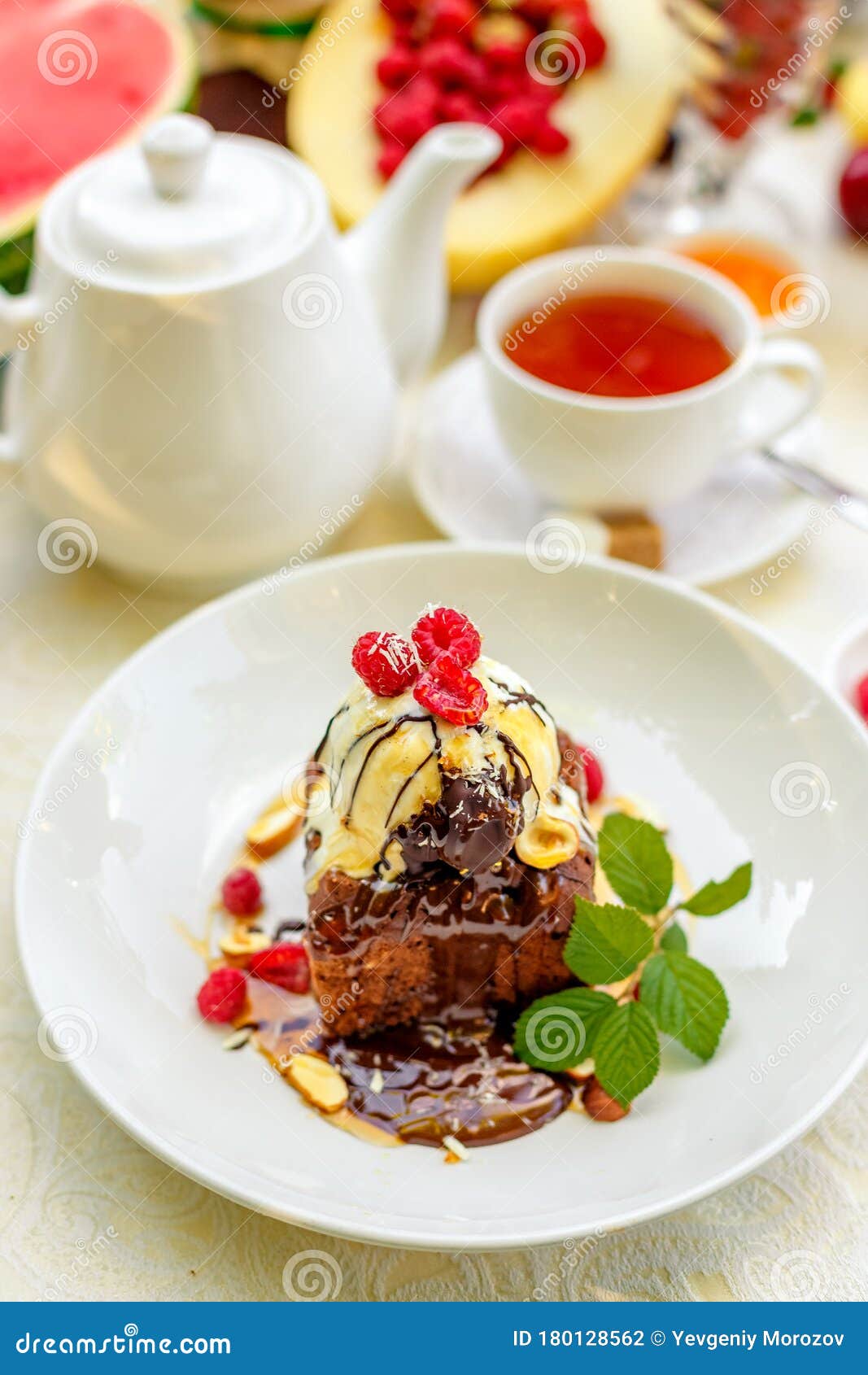 Chocolate Sponge Cake with Ice Cream and Fruit on a Served Table Stock