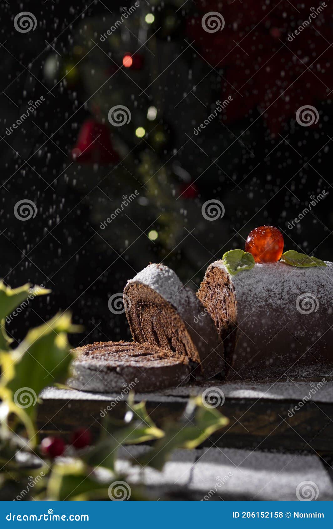 Chocolate Swiss Roll Yule Log Decorated with Sugar Cherry and Icing