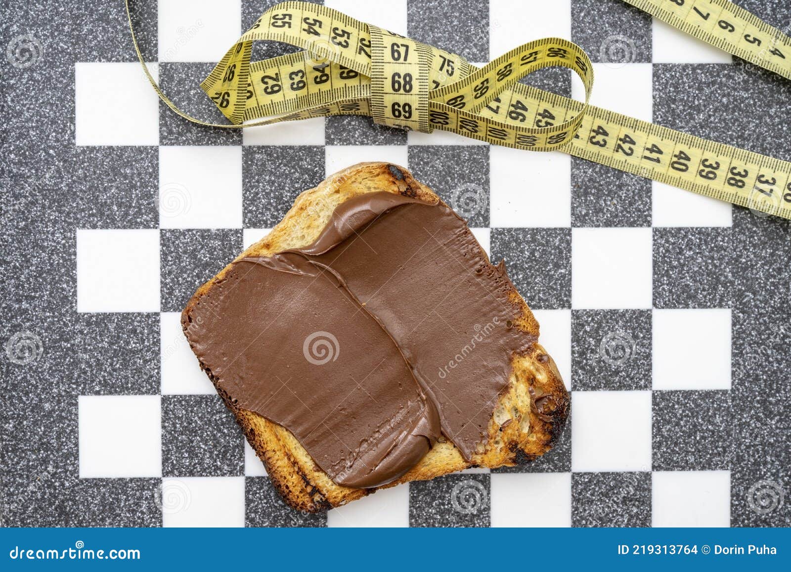 Chocolate on Toast with a Bow Made from Measuring Tape, on a Chess