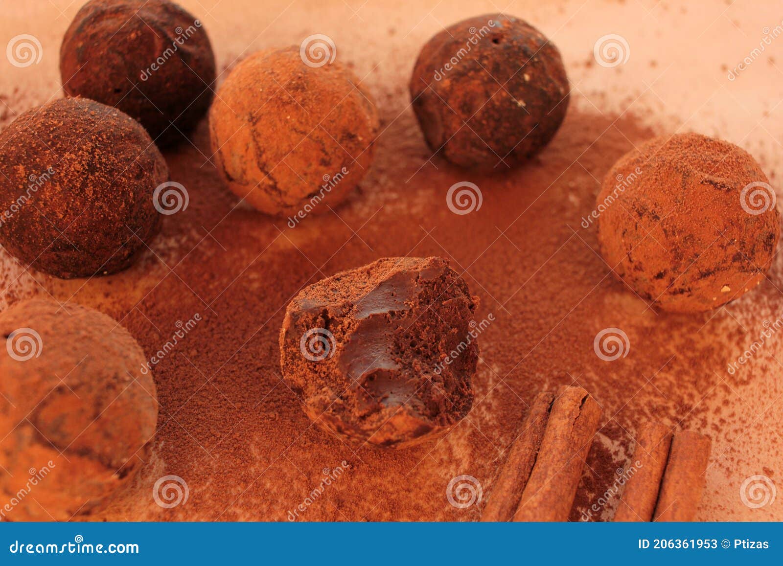 chocolate truffles, cocoa powder and cinnamon sticks on a craft paper background.