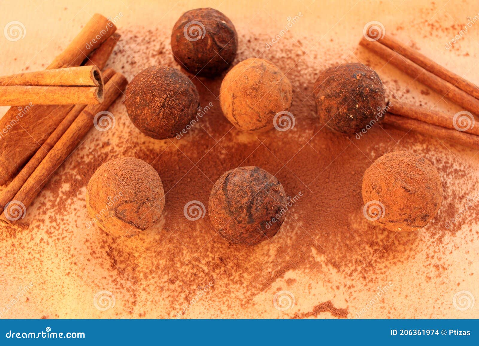 chocolate truffles, cocoa powder and cinnamon sticks on a craft paper background.