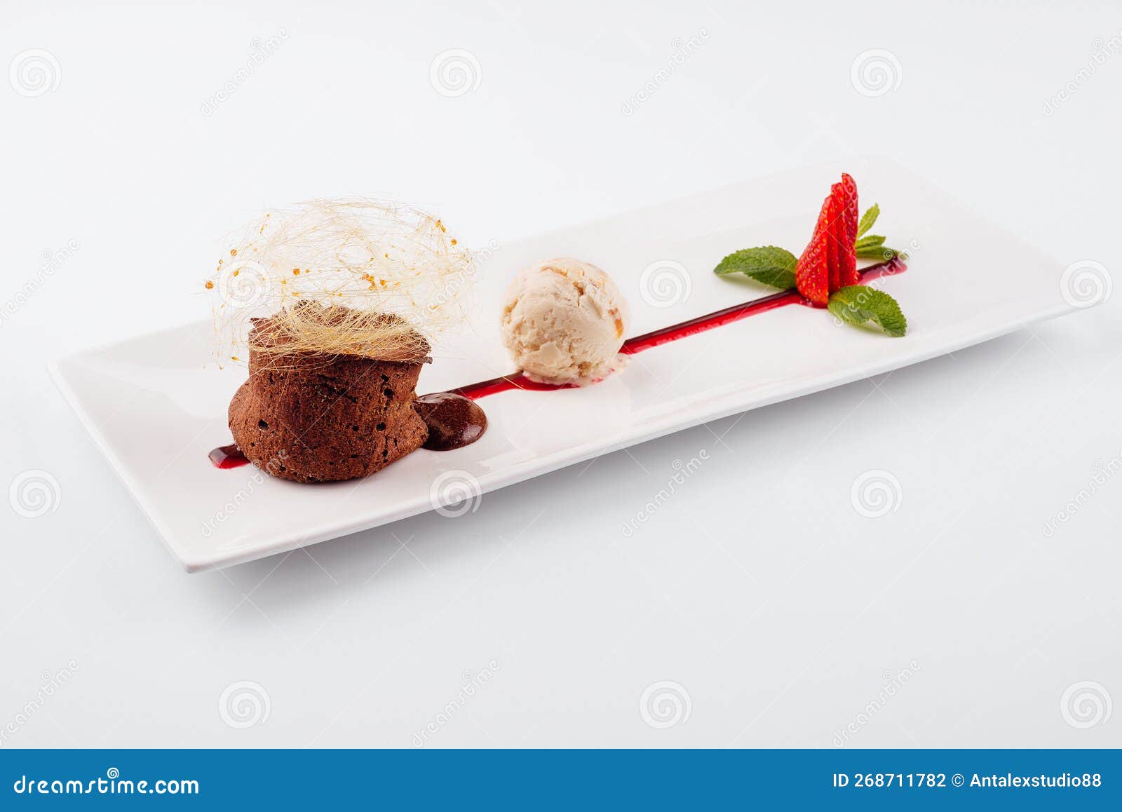 Chocolate Volcano with Vanilla Ice Cream and Strawberry Stock Photo