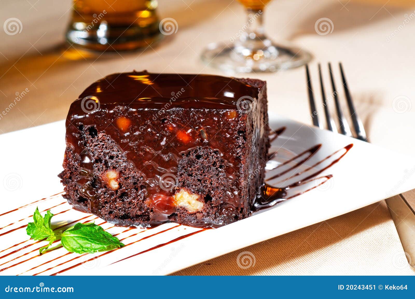 Fresh baked delicious chocolate and walnuts cake with mint leaf beside