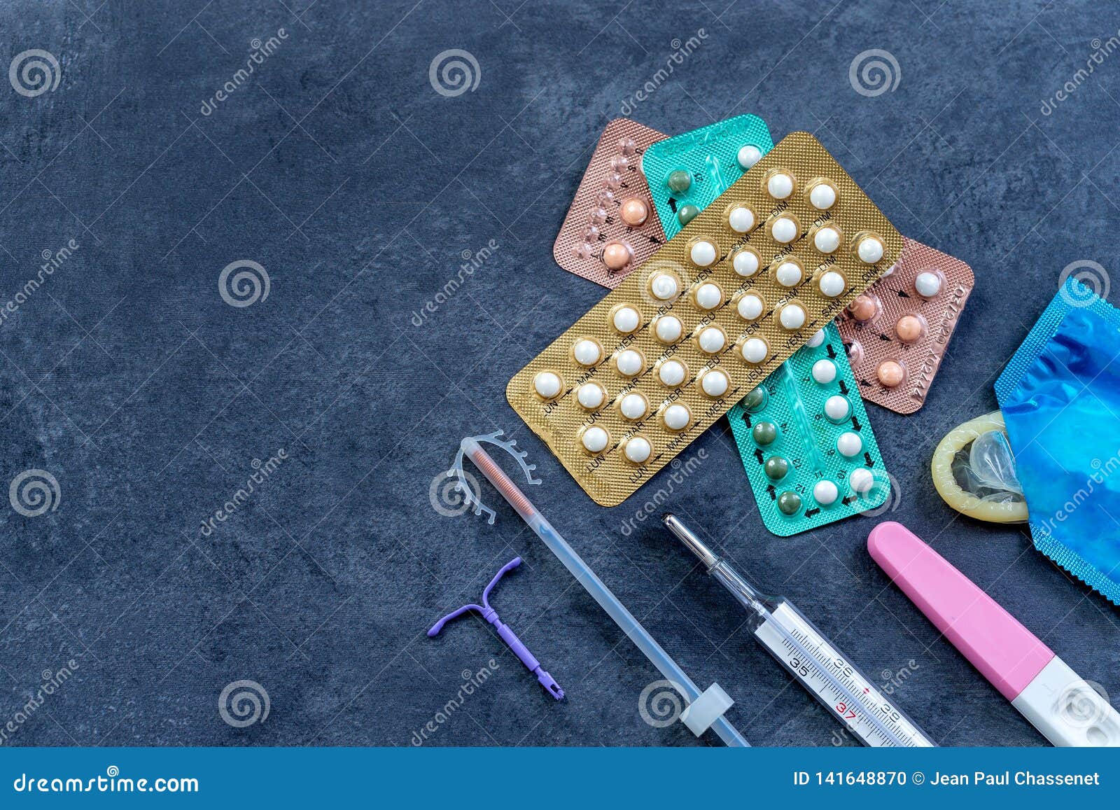 choosing method of contraception : birth control pills, an injection syringe, condom, iud-method, on grey