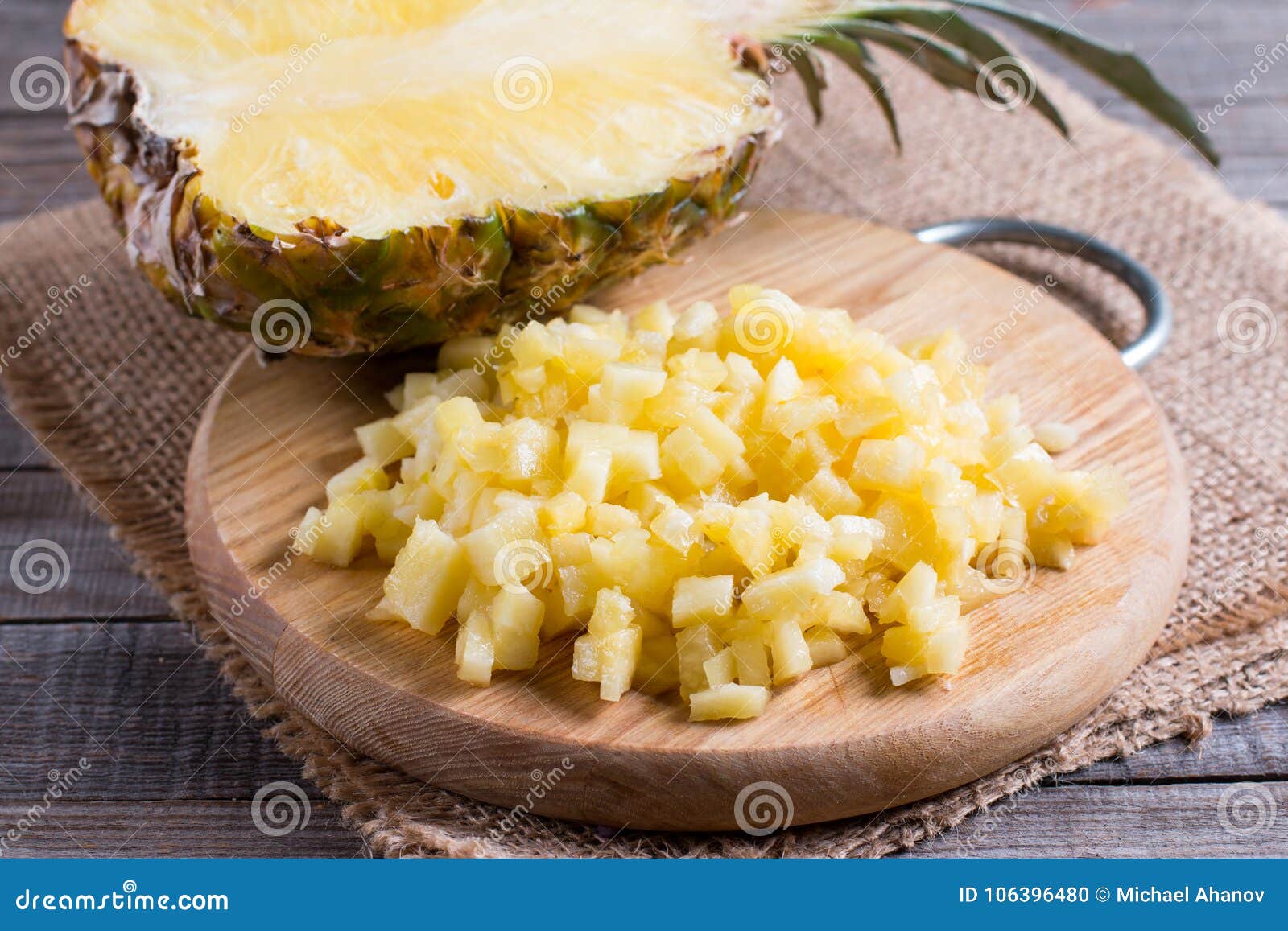 Chopped Dried Pineapple Pieces on Wooden Cutting Board Stock Photo
