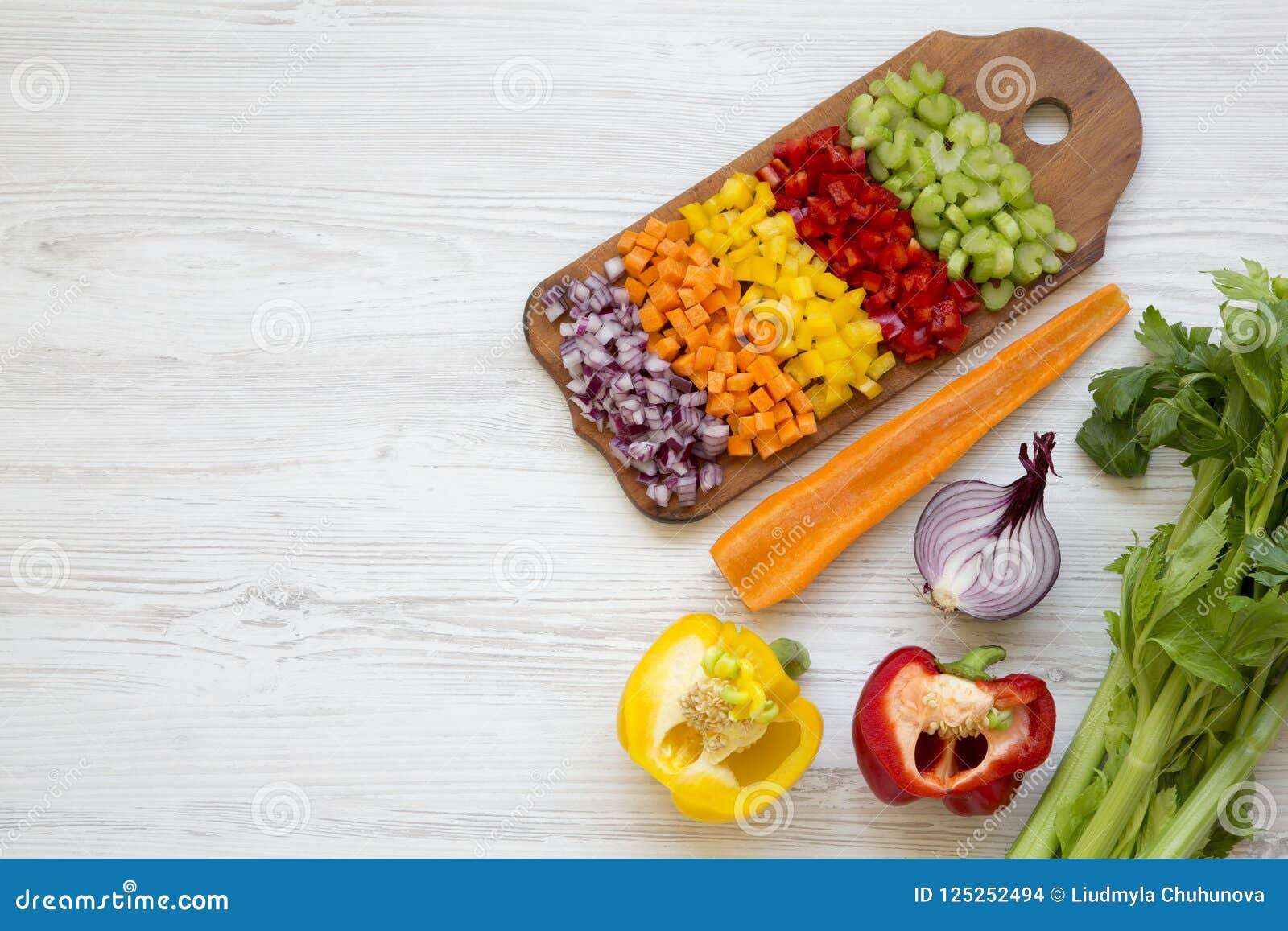 chopped fresh vegetables arranged on cutting board on white wooden table, overhead view. flat lay, from above, top view. copy spa