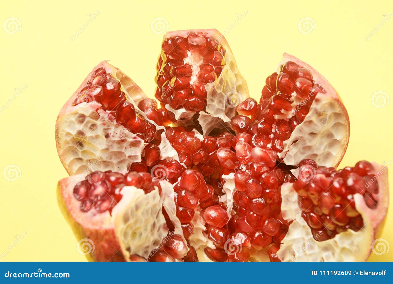 chopped fruit. small red grains. pomegranate slices. yellow background