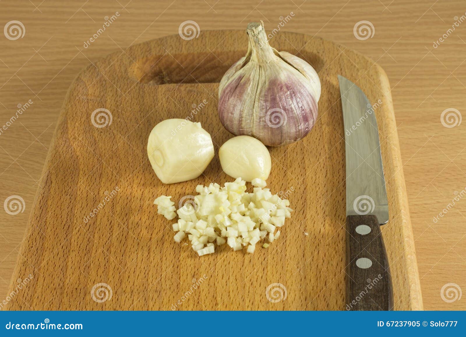 chopped garlic on a wooden cutting board