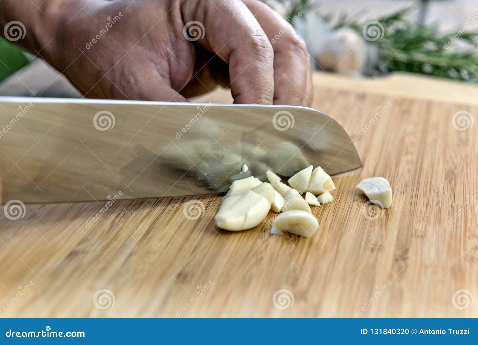 Chopping Garlic with Knife on Cutting Board Stock Photo Image of hand