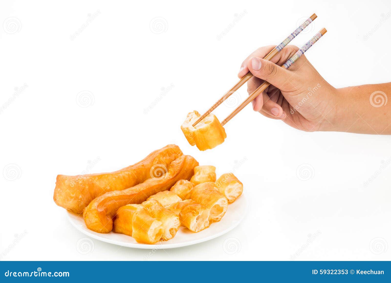 chopsticks reaching for a piece of you tiao, or fried bread stic