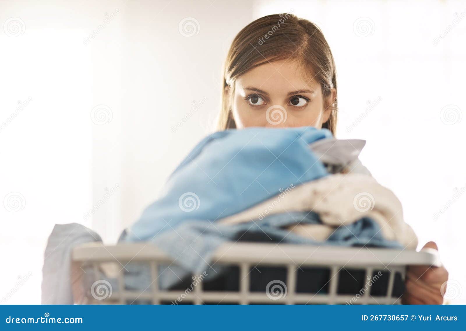 Chore after Chore an Attractive Young Woman Doing Laundry at Home Chore after Chore an Attractive Young Woman Doing Laundry at Home