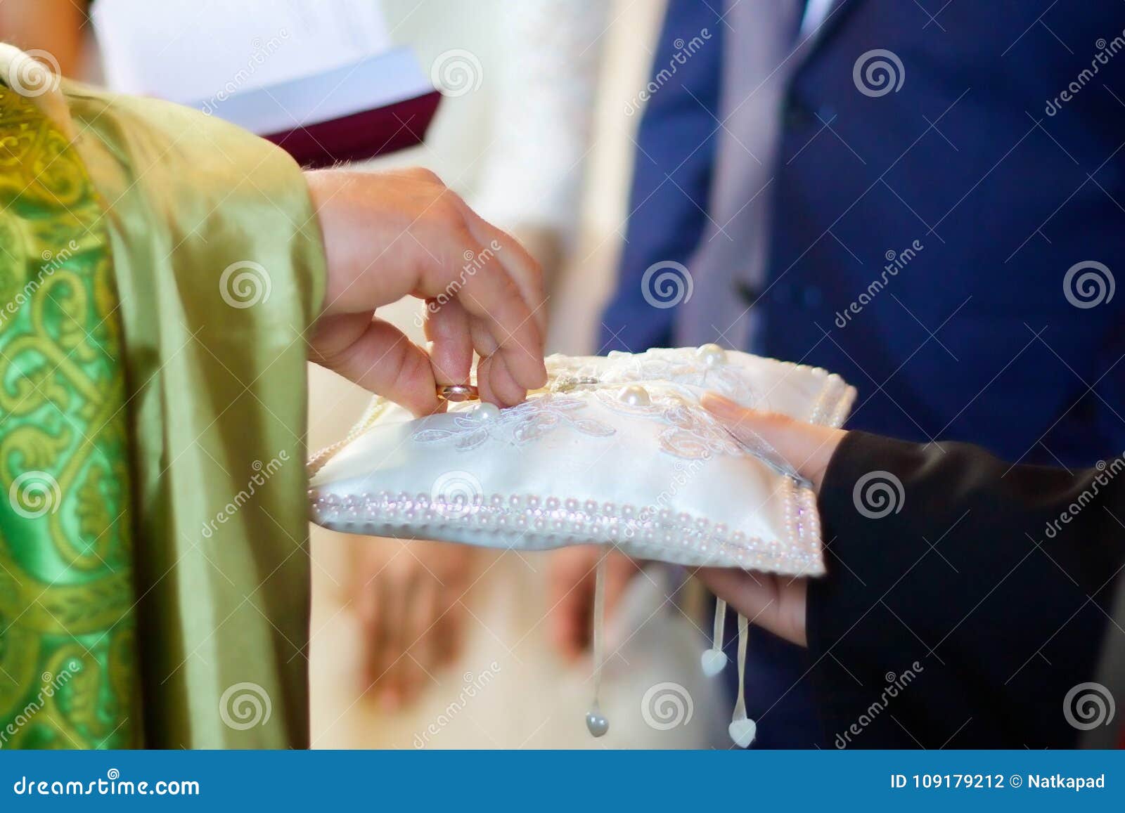 A Christian Priest Holds In His Hands A Wedding Ring