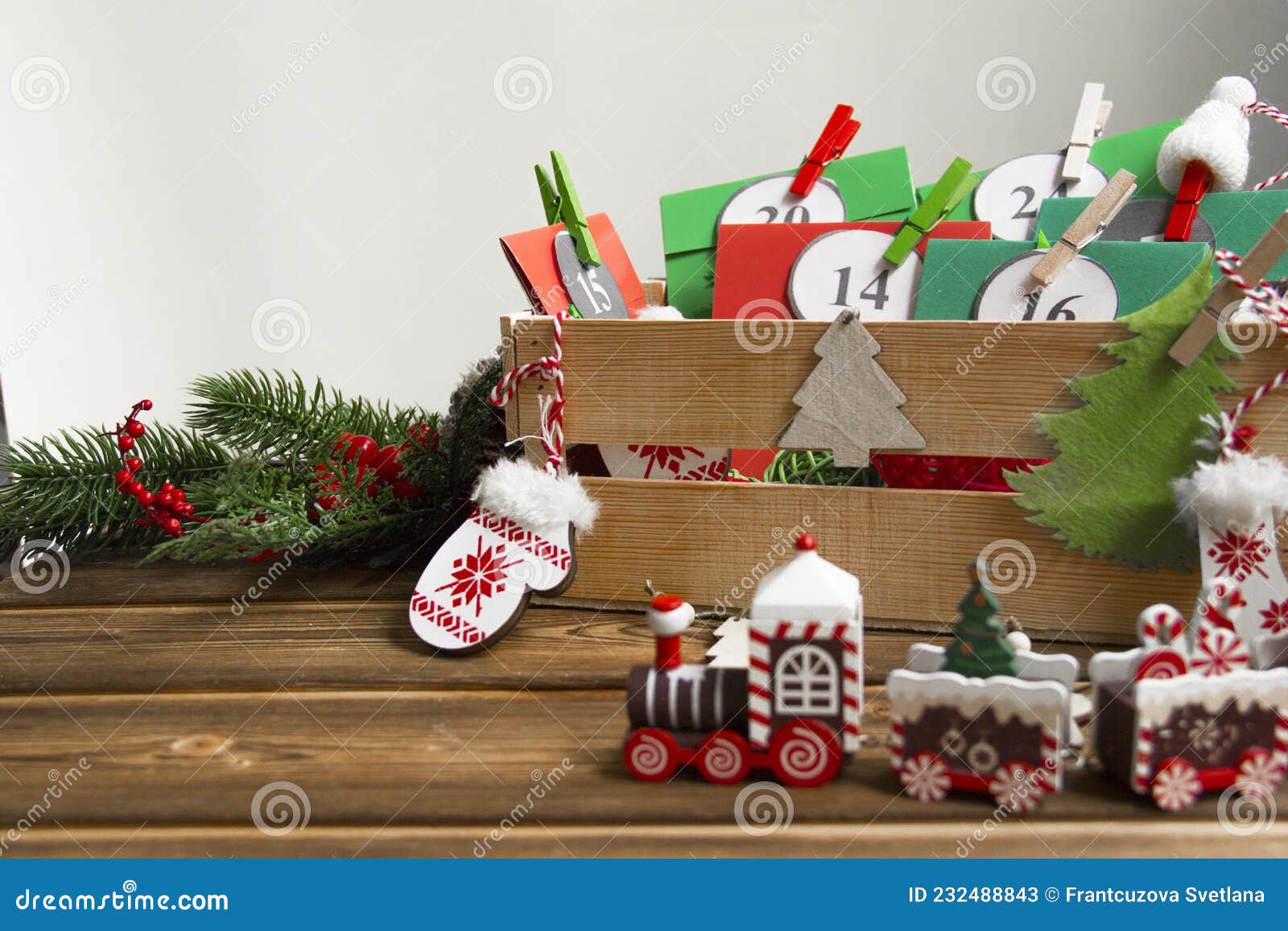 christmas advent calendar on the table, in a wooden box. multicolored envelopes made by hand