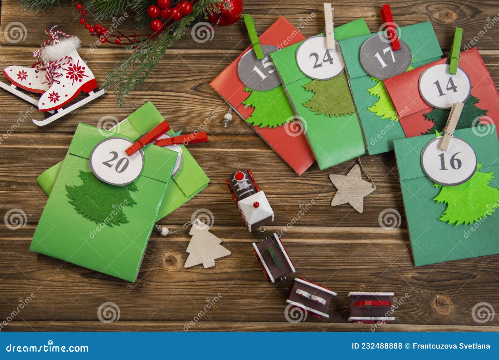 christmas advent calendar on the table, in a wooden box. multicolored envelopes made by hand