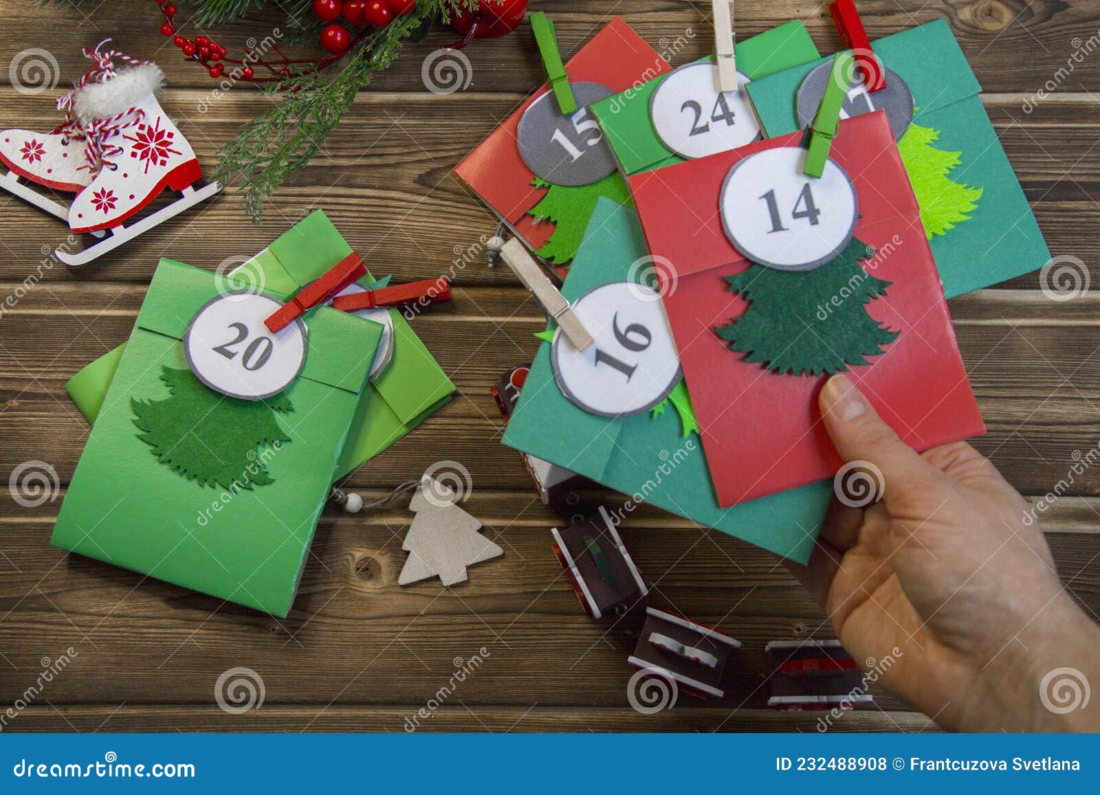 christmas advent calendar on the table, in a wooden box. multicolored envelopes made by hand
