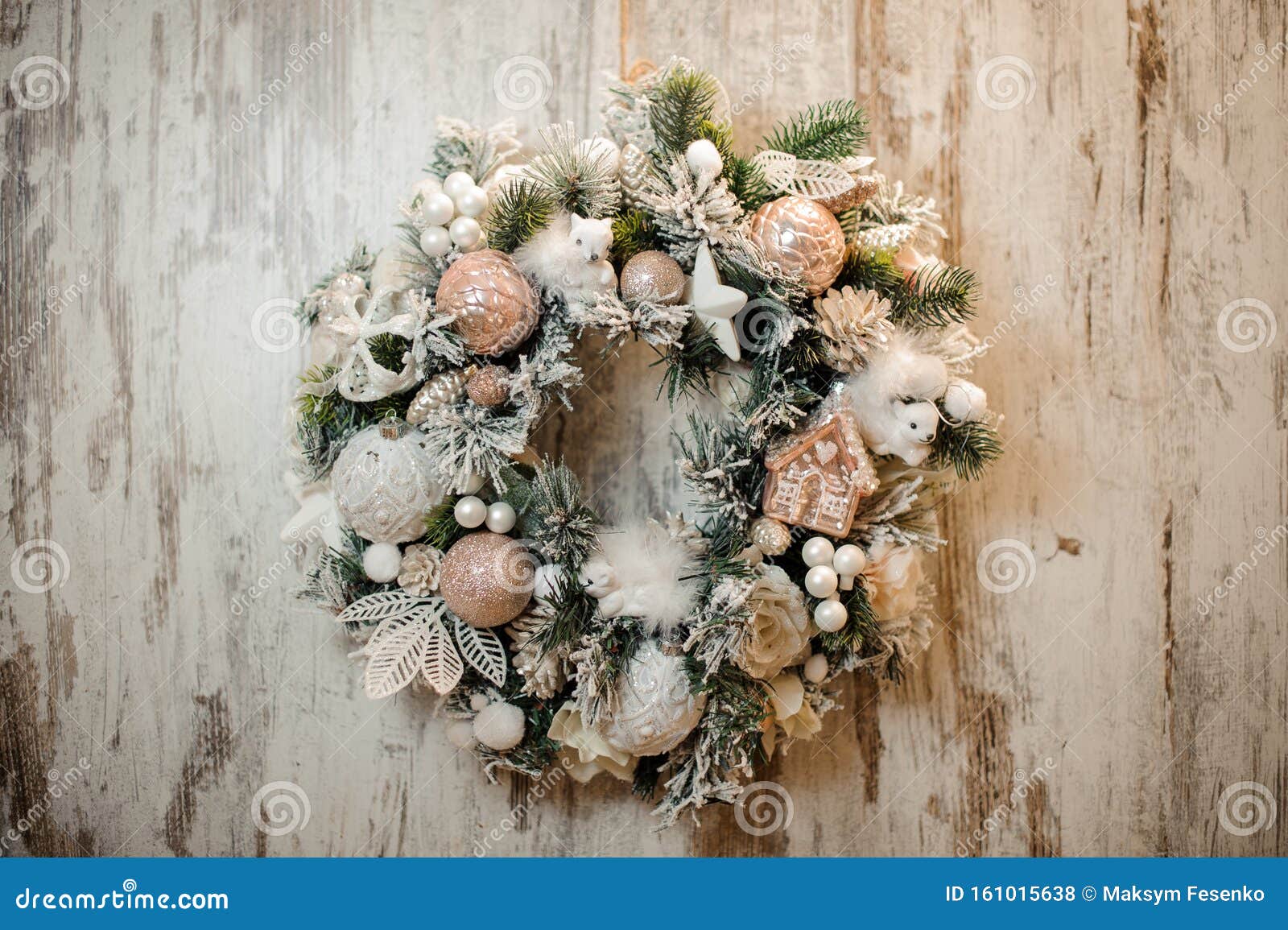 christmas artificial wreath with white and rosa color toys, balls, tapes and flowers