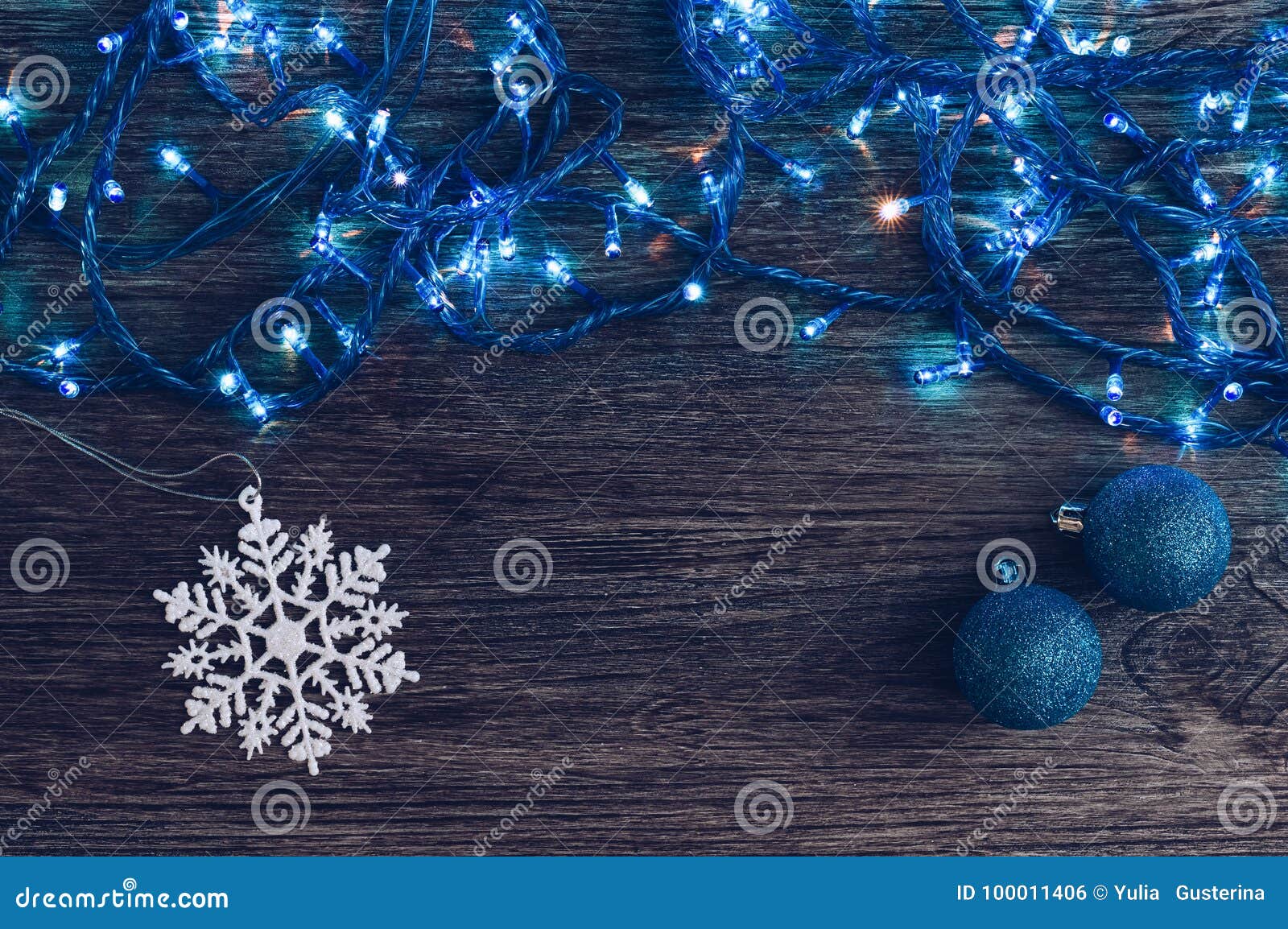 Download Christmas Background With Blue Garland And Lights Christmas Balls And Snowflake Wooden Background