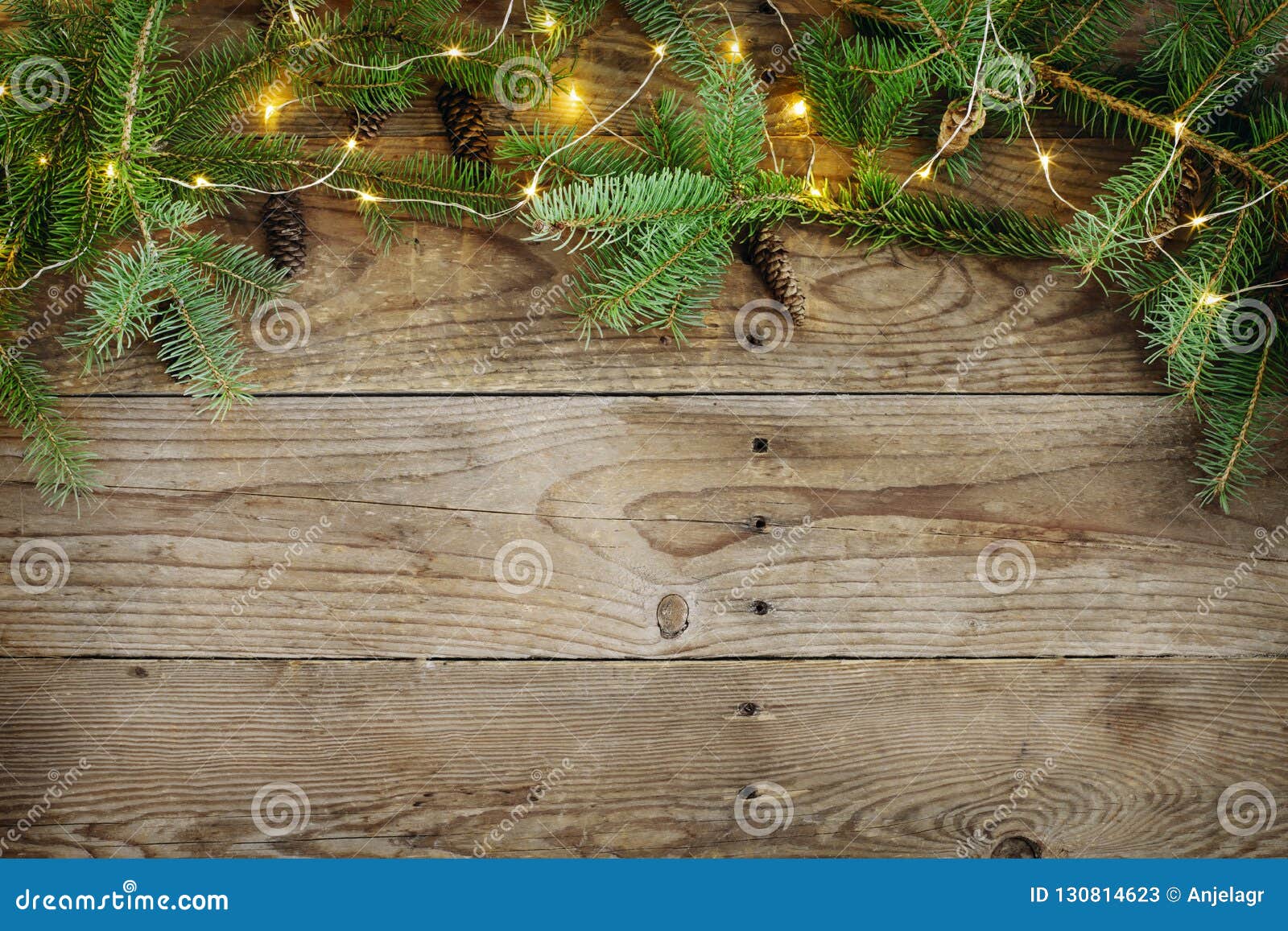 Christmas Background with Fir Tree Branches and Lights on Wooden Board ...