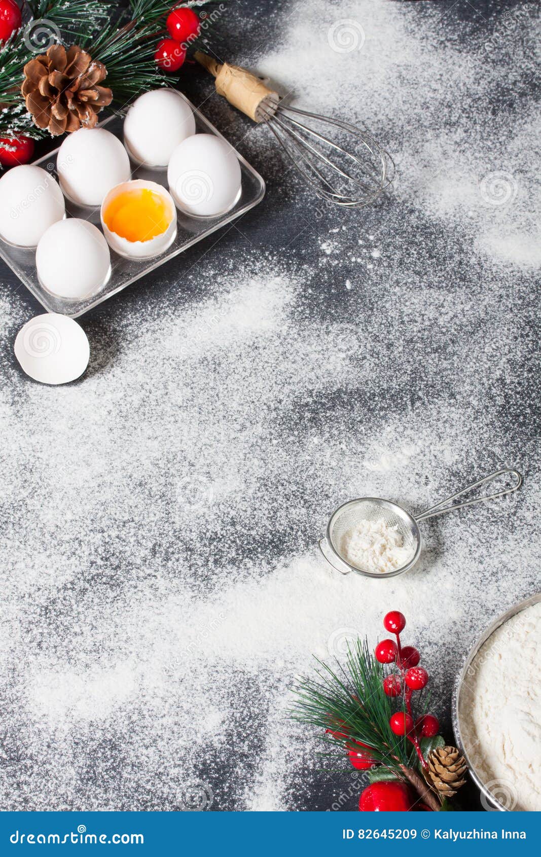 Christmas baking cake background. Ingredients and tools for baking - flour,  eggs, silicone molds in the shape of a Christmas tree, and a rolling pin on  a wooden background. Stock Photo