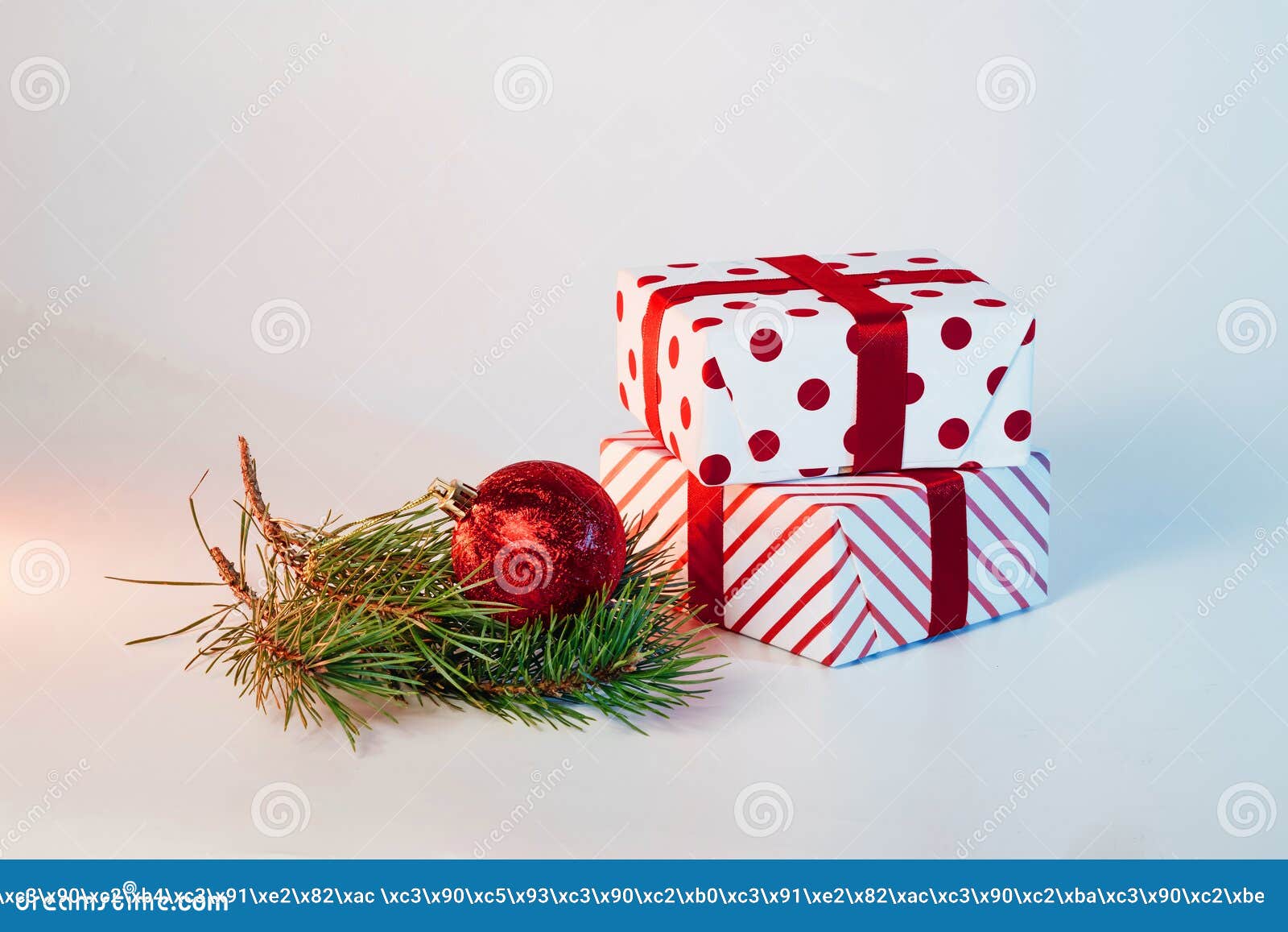 Christmas Ball, Gifts and Green Spruce Branches on a White Background