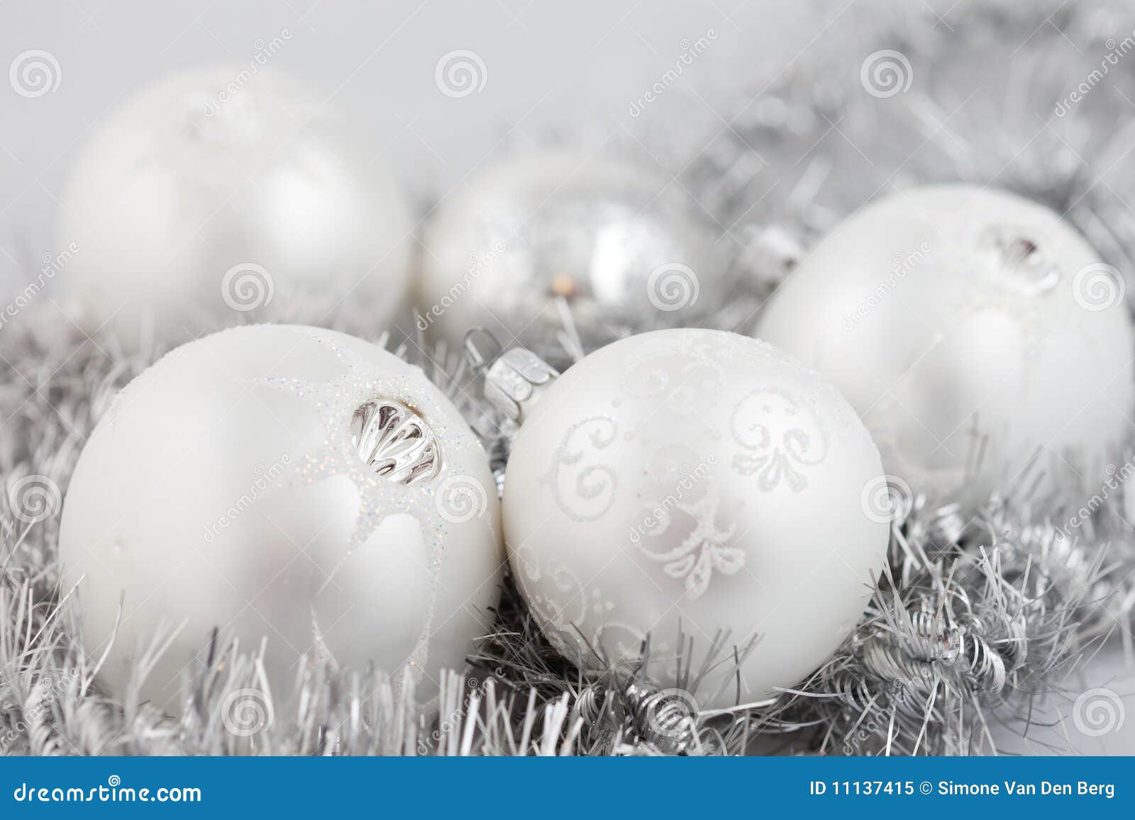 Collection of christmas baubles on silver background