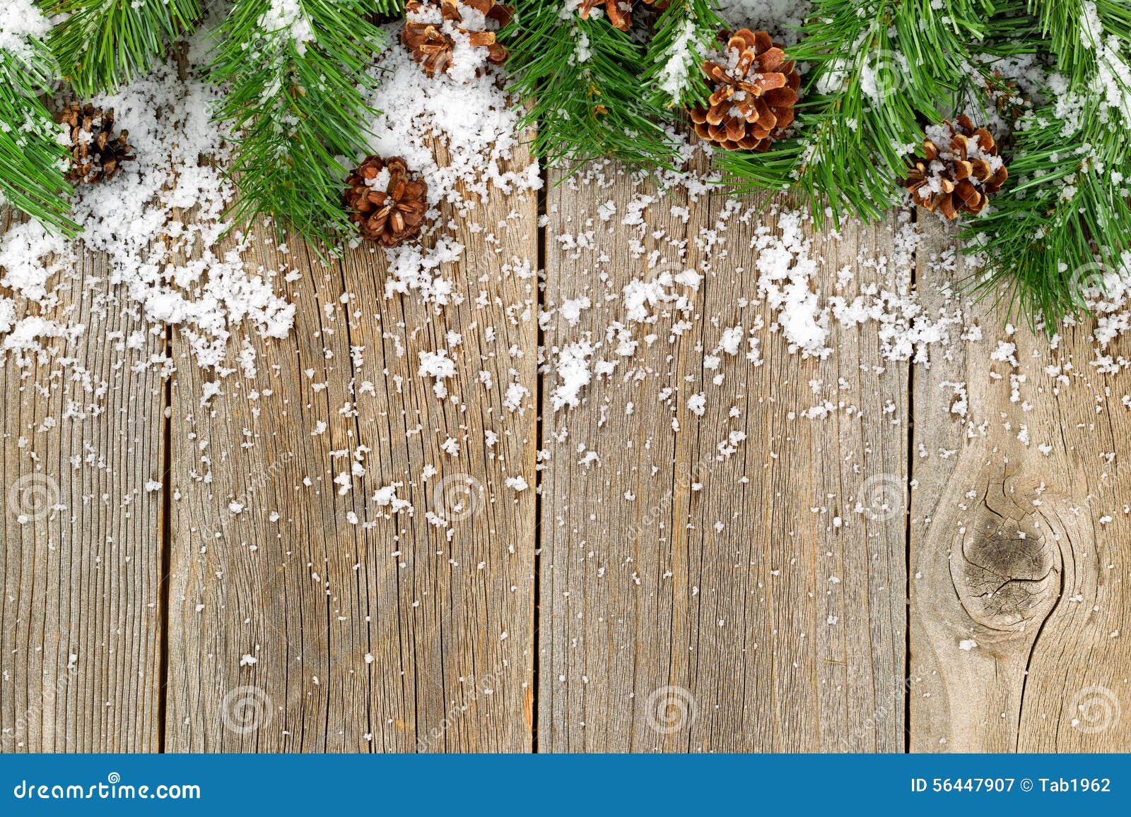 Christmas holiday border with evergreen branches on rustic cedar