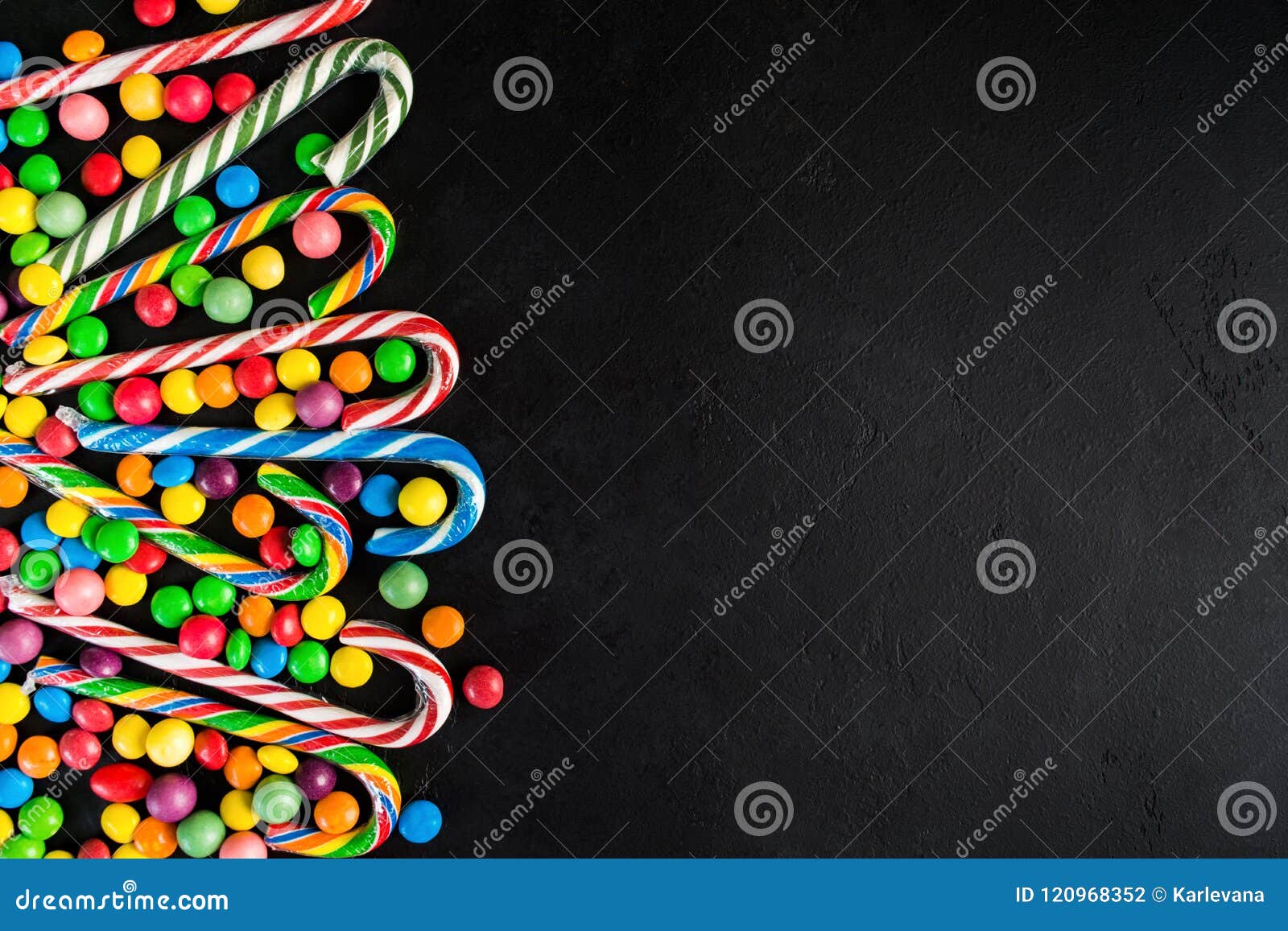 Christmas Candy Cane with Candy Drops Over Black Background with Stock