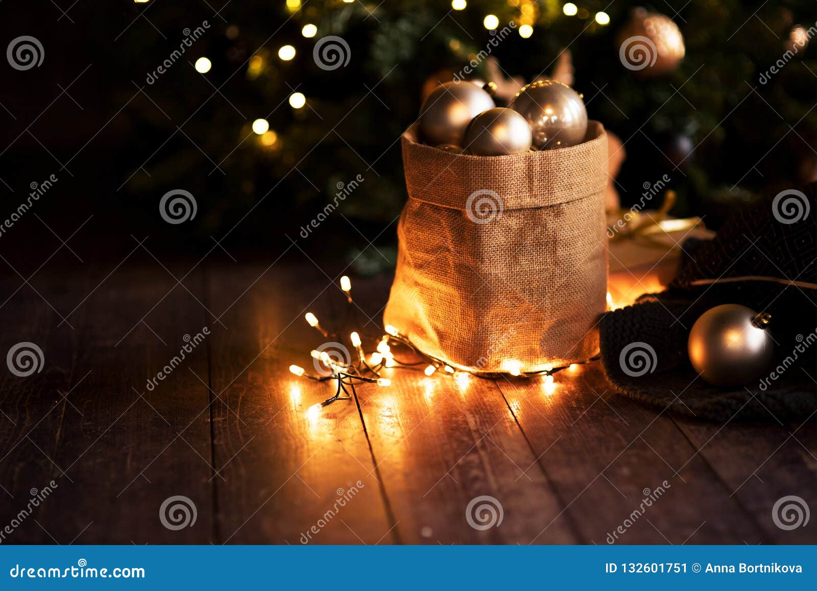 christmas canvas bag with balls and lights on the dark boards, the new year concept