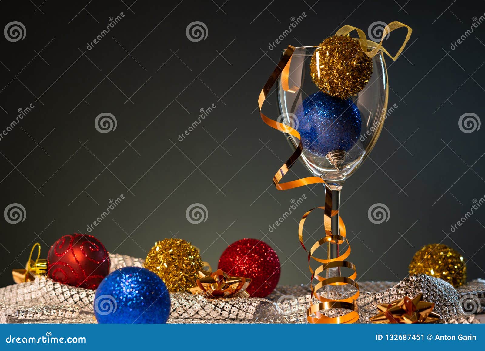 christmas cards. wine glass with red, blue and gold christmas decorations