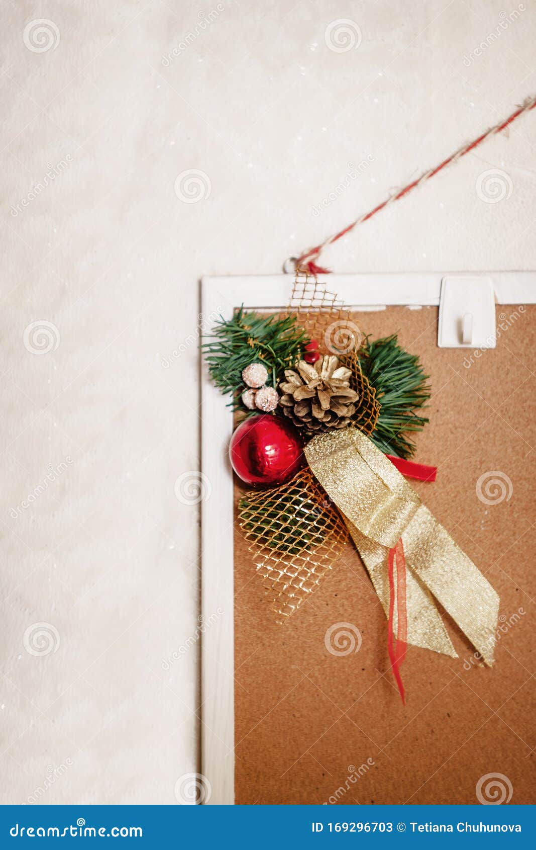 christmas decor decoration from fir branches, balls and ribbons hanging on a home mudboard on a white background.