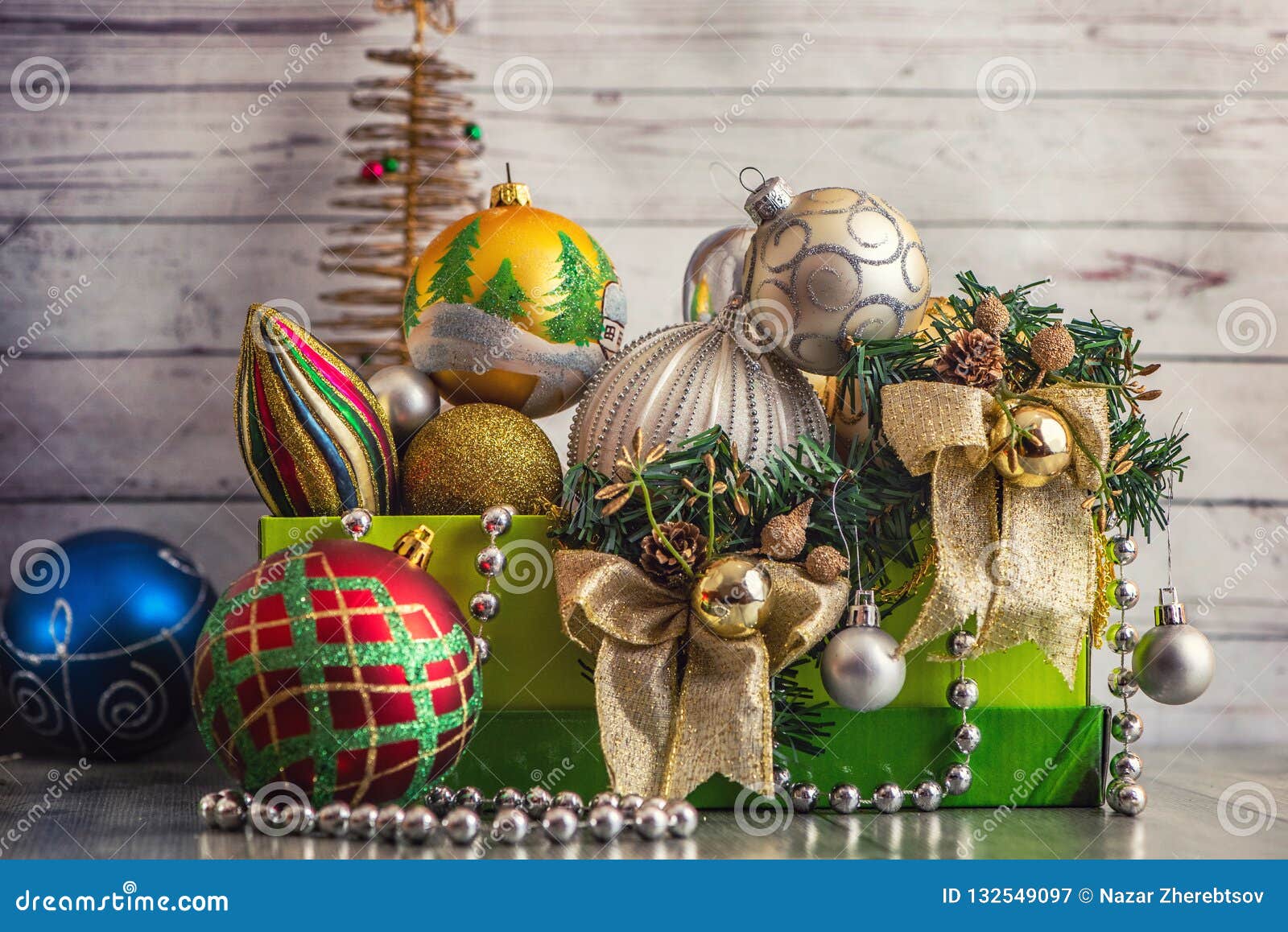 Christmas Decorations in Green Box on Light Wooden Background Stock ...