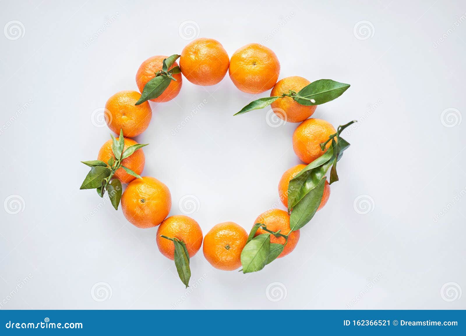 Christmas Fruit. Orange Fresh Tangerines or Mandarines with Green Leaves in  a Paper Bag Lie on a White Background Stock Image - Image of natural, leaf:  162366521