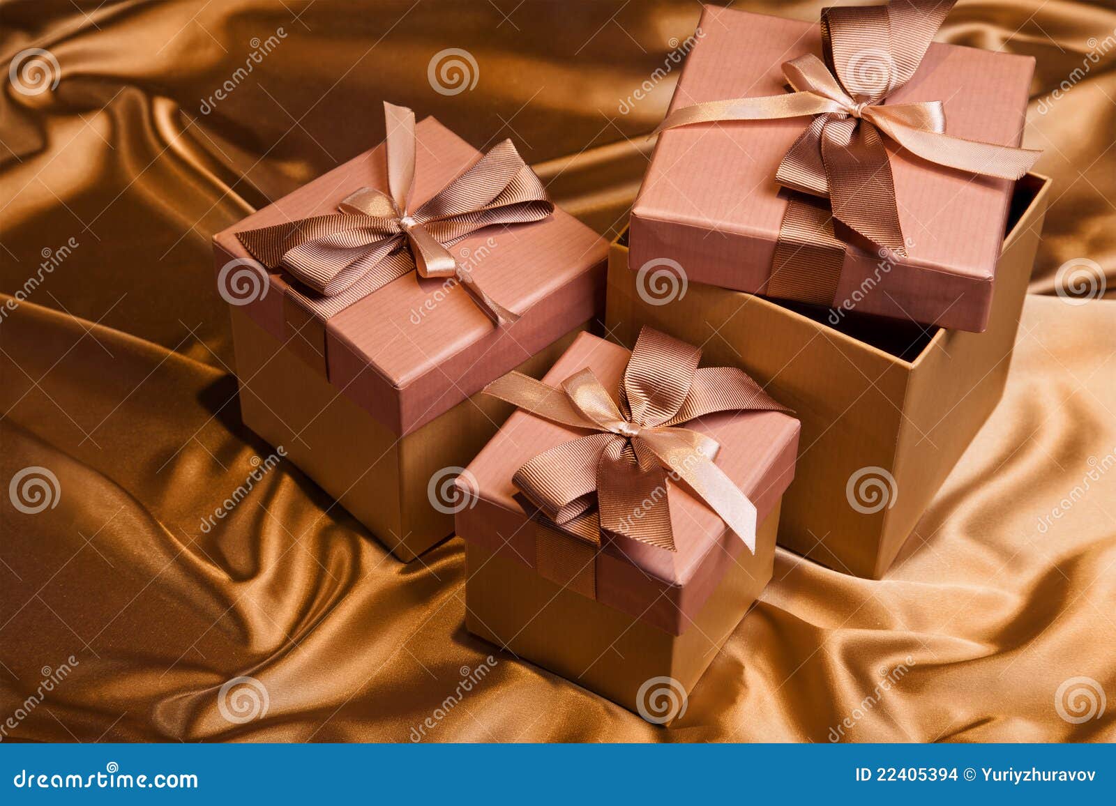 Christmas Gift Box On Yellow Bright Satin Stock Photo