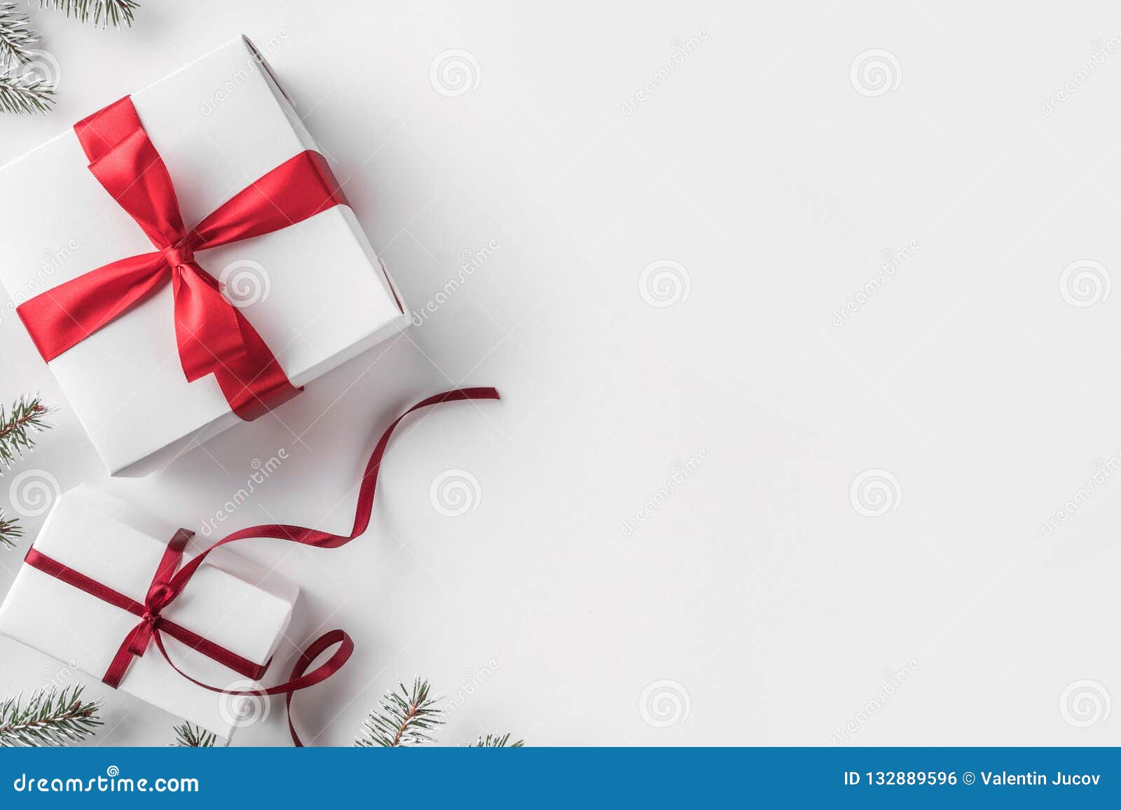 Christmas and Happy New Year red background with boxes, ribbons