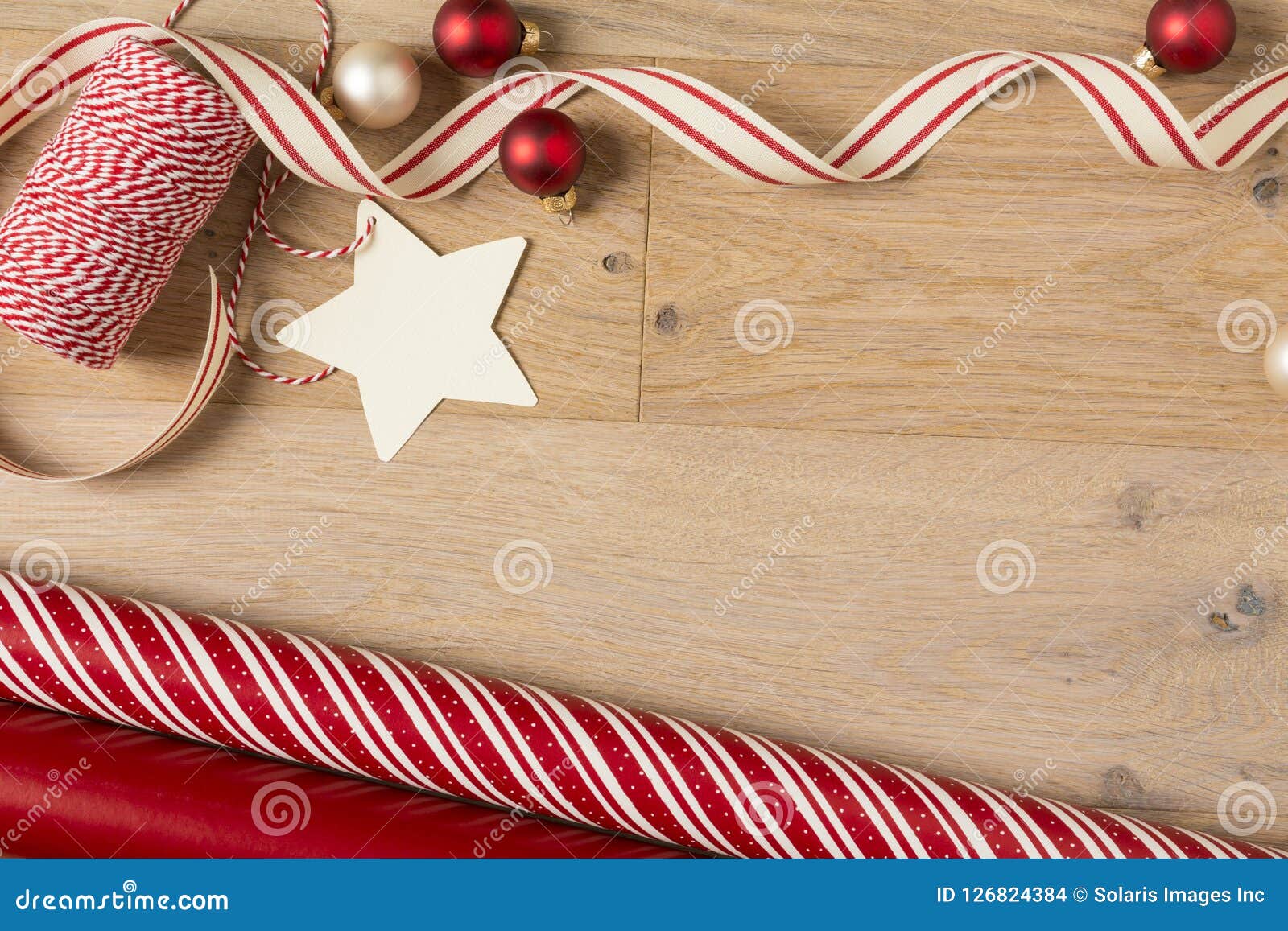 christmas gift wrapping paper and ribbons supplies on wood background