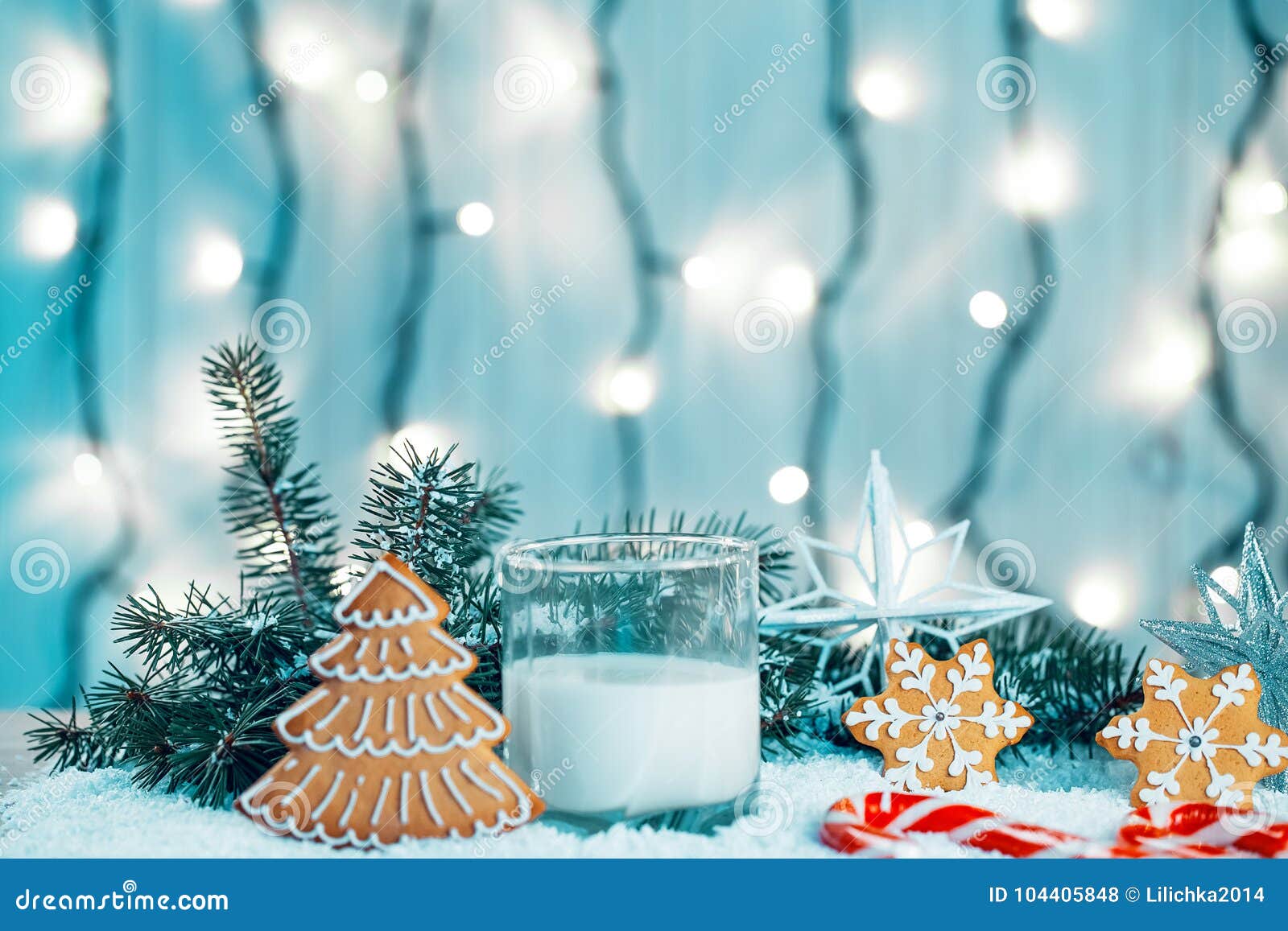 Christmas gingerbread and milk with decorations snow christmas tree branches on bokeh blurred lights background Free space