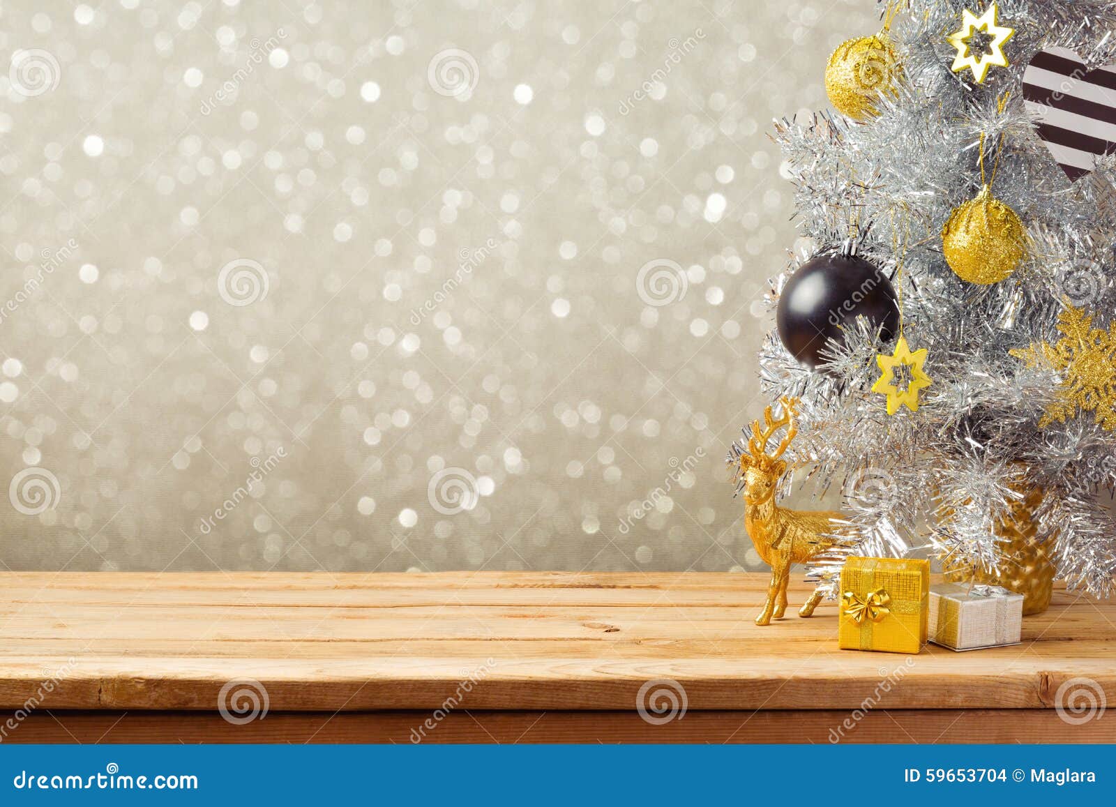 christmas holiday background with christmas tree and decorations on wooden table. black, golden and silver ornaments