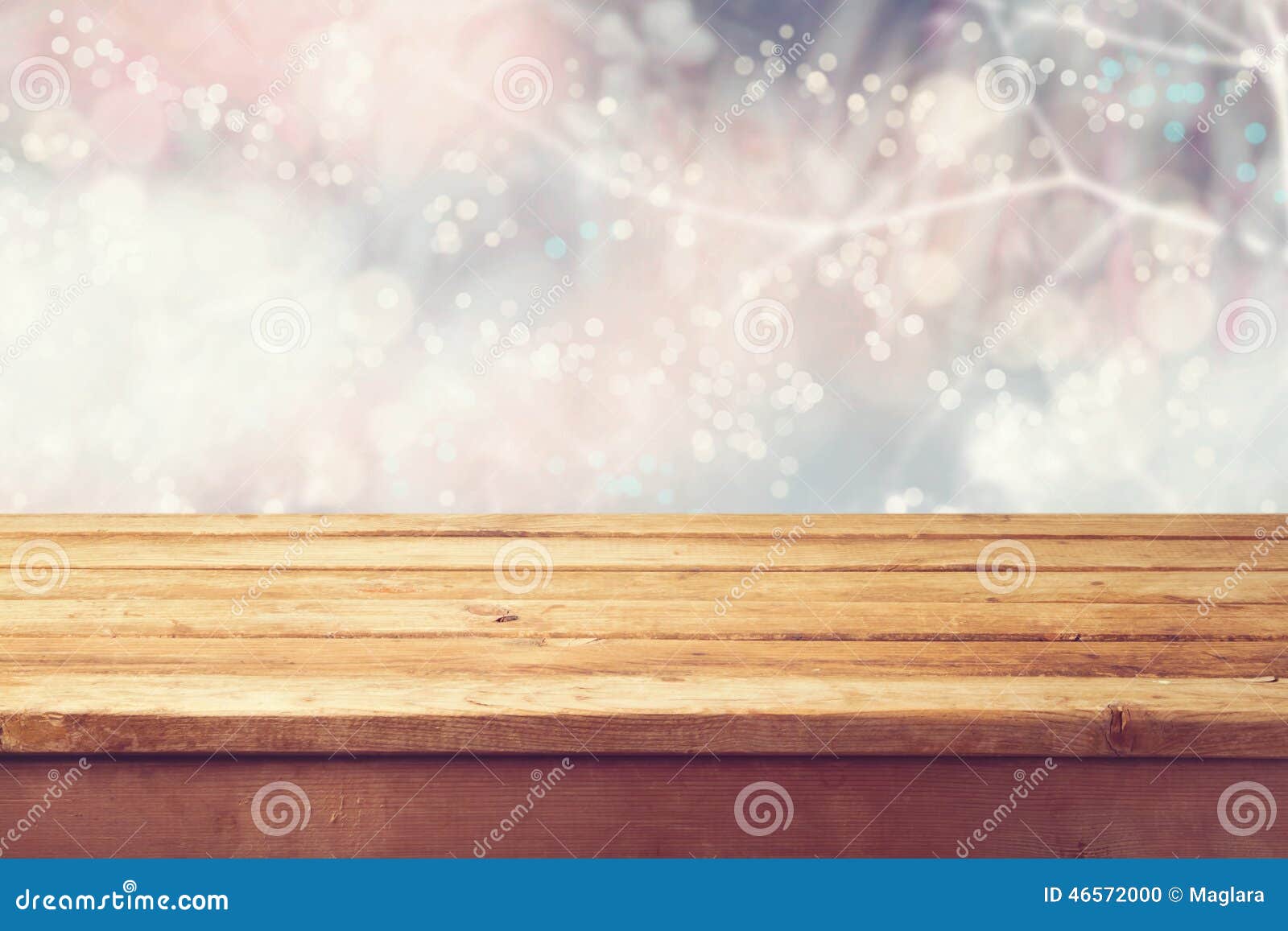 christmas holiday background with empty wooden deck table over winter bokeh. ready for product montage