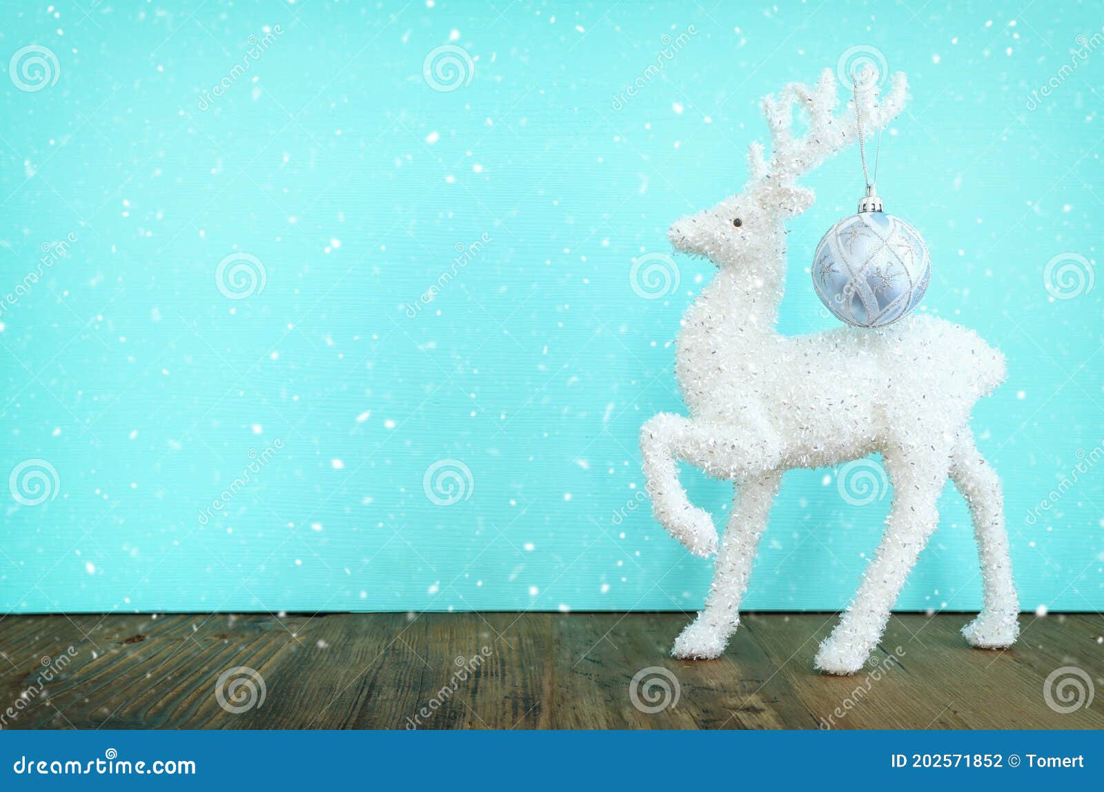 Christmas Image with White Deer Over Pastel Blue Background Stock Photo