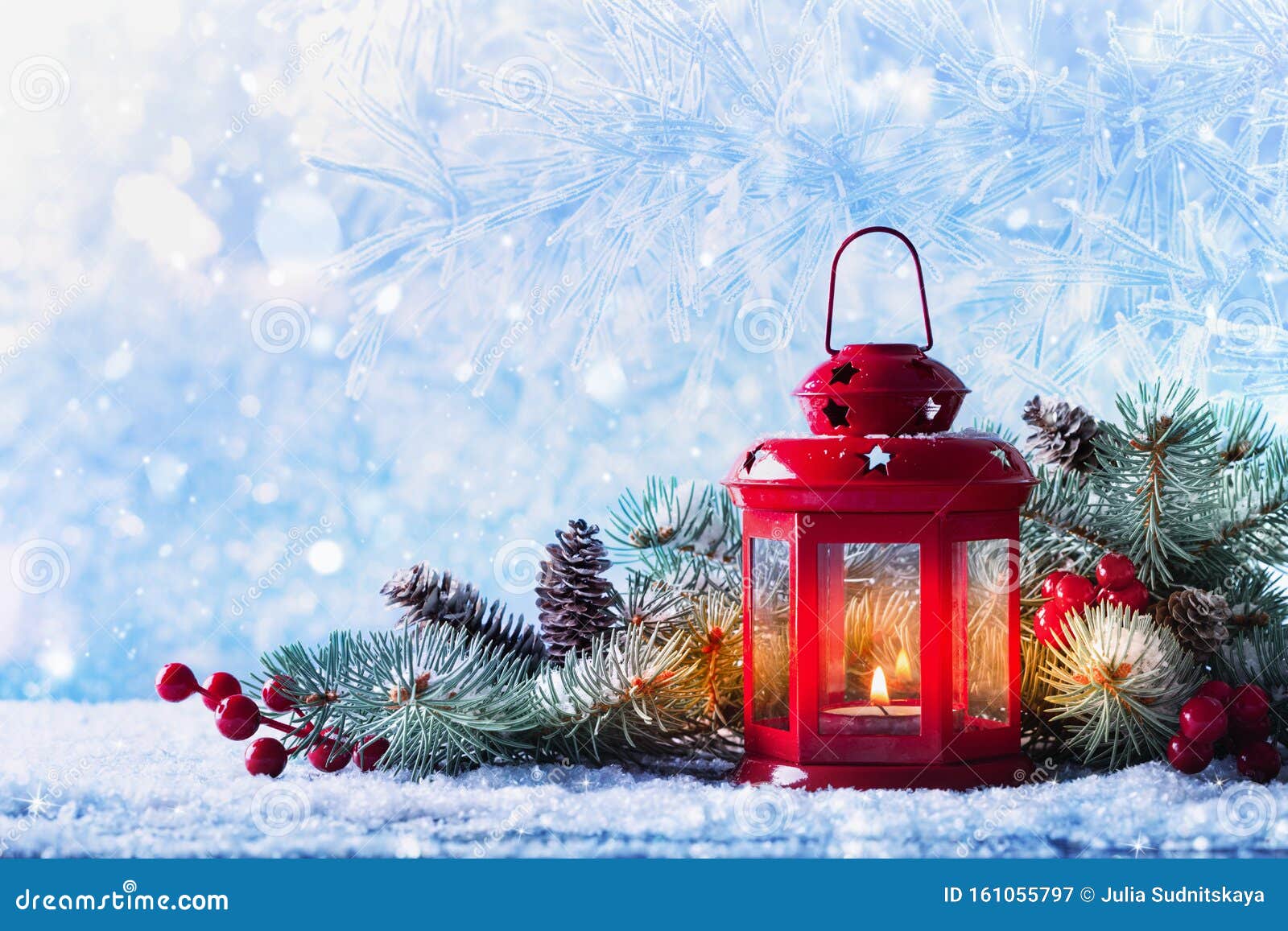 Christmas lantern in snow with fir tree branch. Winter cozy scene
