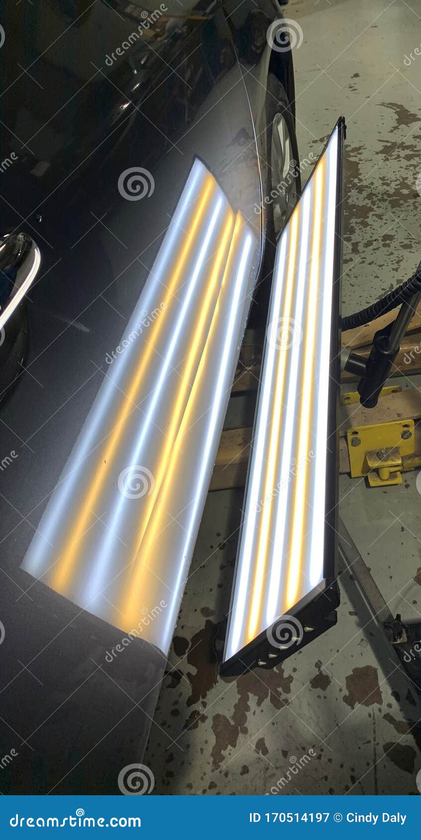 A Paintless Dent Repair Light on a Car Door Showing a Horizontal Crease