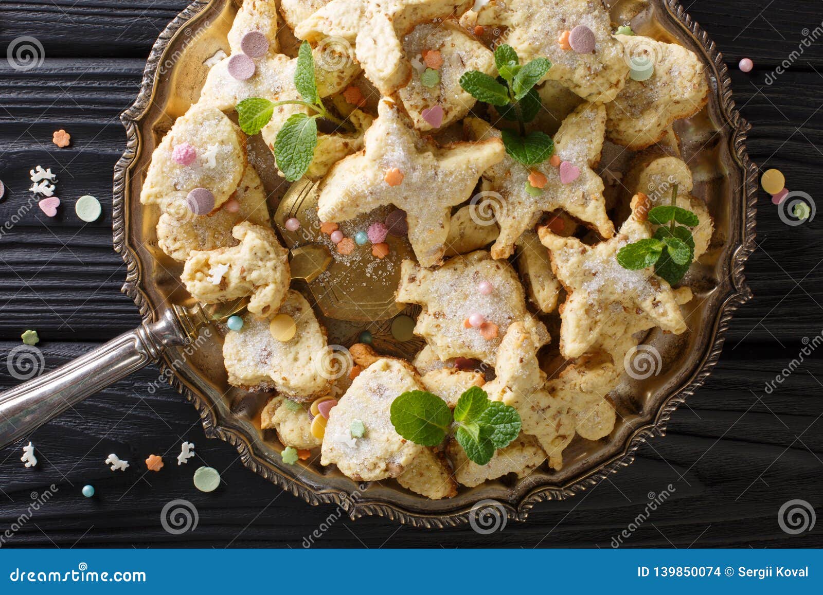 christmas mexican cookies hojarascas or biscochitos, pan de polvo and polvorones closeup on a plate. horizontal top view