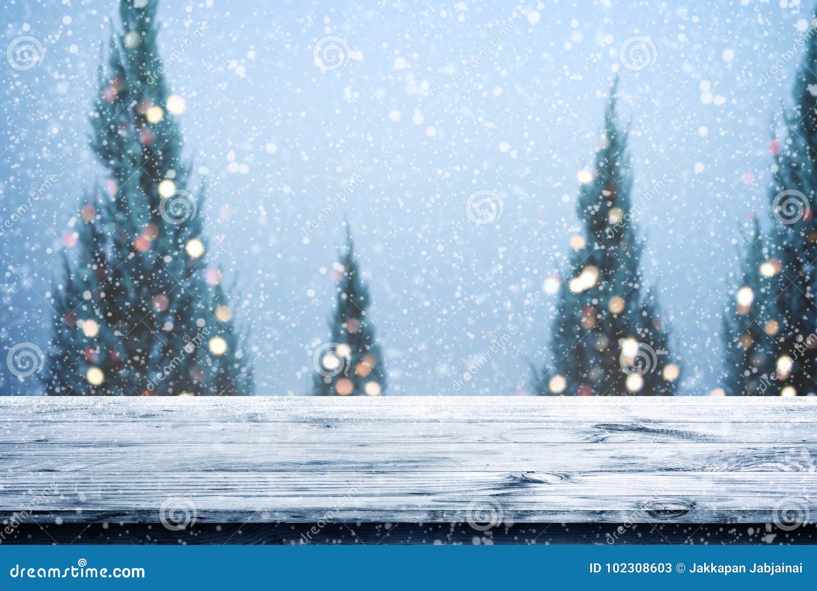 christmas and new year background with wooden deck table over christmas tree,