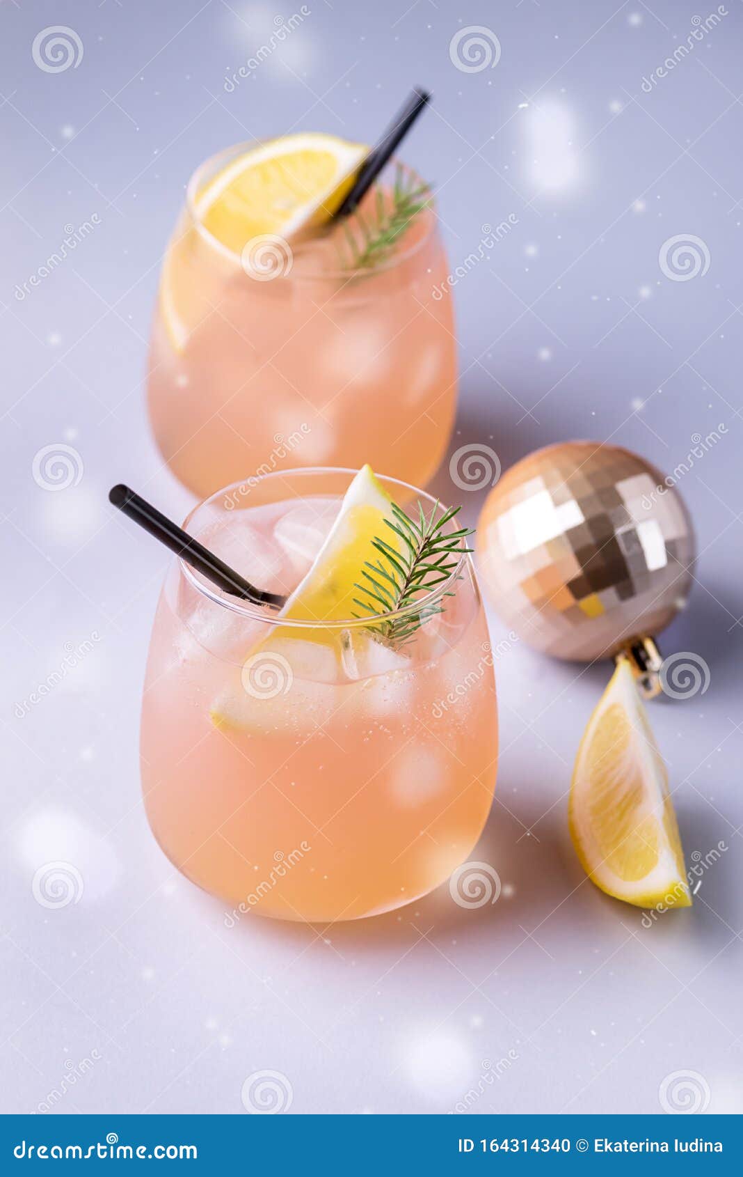 christmas or new year party cocktail with citrus glass of grapfruit beverage decorated with slice of lemon and fir branches straw