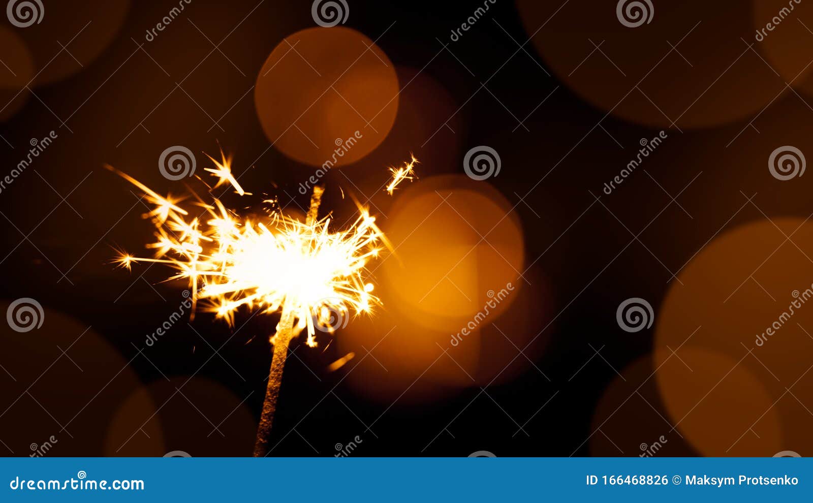 Christmas And New Year Sparkler On Black Background With Blurred Lights